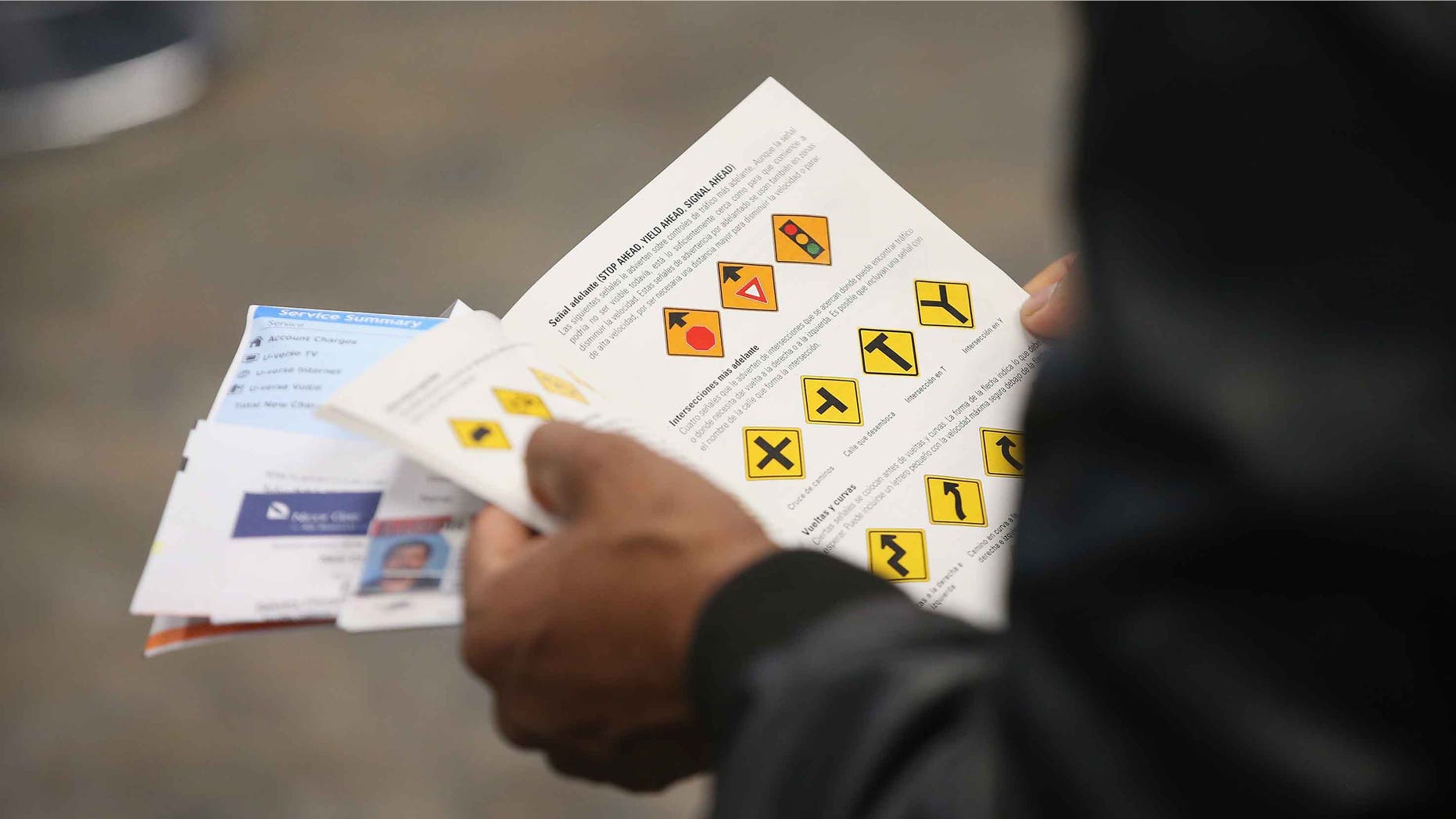 CHICAGO, IL - DECEMBER 10: An Illinois resident uses a Spanish-language study guide to prepare for his driver's license exam at a driver services facility on December 10, 2013 in Chicago, Illinois. Illinois recently began a Temporary Visitors Driver's License (TVDL) program which allows undocumented immigrants to obtain a driver's license. The applicants must have an Illinois address, prove 12 months of residency in the state, and have a valid passport or consular card to be eligible. (Photo by Scott Olson/Getty Images)