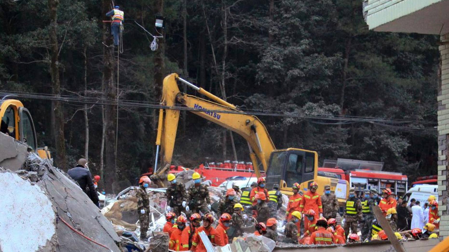 Rescuers search for survivors at the site of collapsed homes in Dahui village, Baizhangji township in Wencheng county in east China's Zhejiang province, Thursday, Feb. 2, 2017. Several people were buried in the collapse of a group of homes in eastern China on Thursday morning, a Chinese rescue official and state media reported. (Chinatopix via AP)