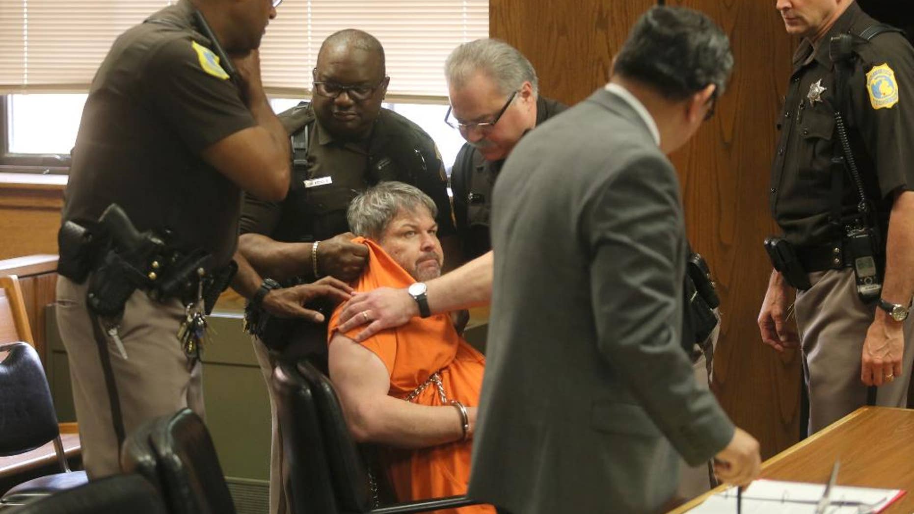 Kalamazoo County Deputies try to remove Jason Dalton after an outburst during his preliminary examination in district court on Friday, May 20, 2016 in Kalamazoo, Mich. Prosecutors say Dalton gunned down six people and wounded two others in the Kalamazoo area over several hours on Feb. 20 while driving for Uber that night. ( Mark Bugnaski/Kalamazoo Gazette-MLive Media Group via AP, Pool)