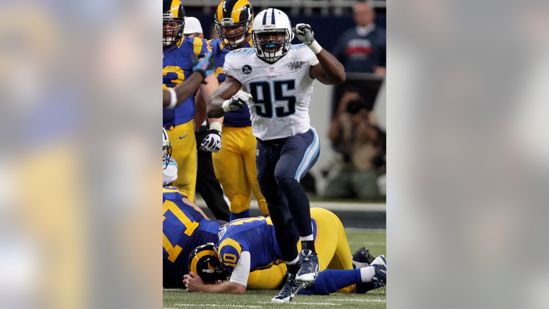 Tennessee Titans defensive end Kamerion Wimbley (95) celebrates after a fumble by St. Louis Rams quarterback Kellen Clemens (10) during the fourth quarter of an NFL football game Sunday, Nov. 3, 2013, in St. Louis. The Titans recovered the fumble and were able to score on the ensuing drive helping them earn 28-21 victory. (AP Photo/Tom Gannam)