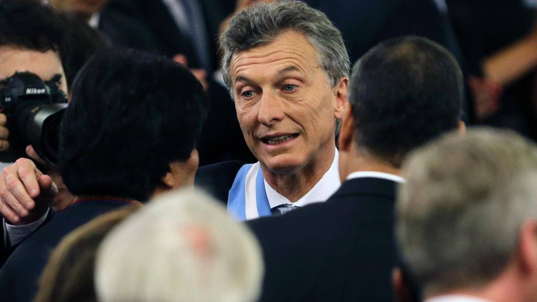 Argentina's President Mauricio Macri, center, meets Bolivia's President Evo Morales, left, and Ecuador's President Rafael Correa, right, after receiving the presidential sash at the government house in Buenos Aires, Argentina, Thursday, Dec. 10, 2015. Macri, the former mayor of Buenos Aires who hails from one of Argentina's richest families, took the oath of office in Congress in front of legislators, several Latin American heads of state and other dignitaries. (AP Photo/Victor R. Caivano)