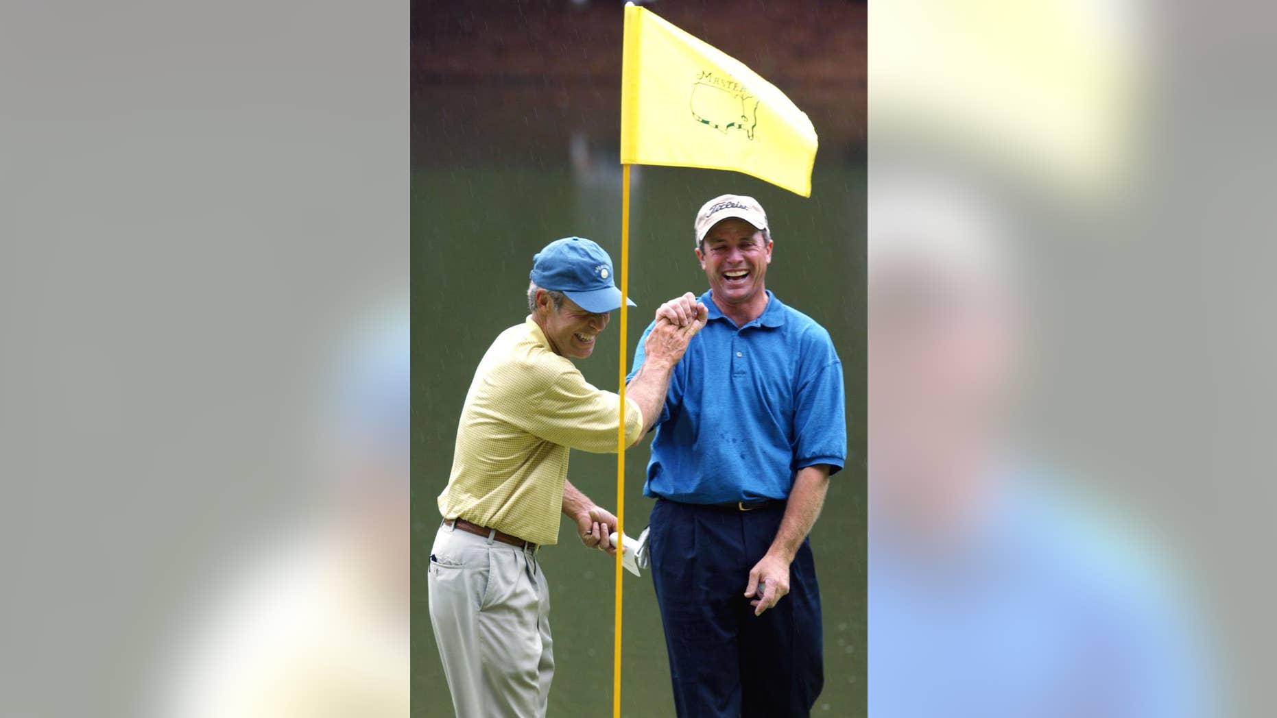 FILE - In this April 10, 2003, file photo, Jerry Pate, right, is all smiles as he is greeted by Ben Crenshaw, left, at the ninth green after sinking the ball for par on a penalty shot from the tee box in the Masters' Par 3 Contest at the Augusta National Golf Club in Augusta, Ga. Augusta National has sent letters to its honorary invitees to inform them that the Par 3 Contest will be limited to players in the field and past Masters champions. U.S. Open, British Open and PGA Championship winners are exempt to the Masters for five years. After that, they become "honorary invitees," along with all past U.S. Amateur champions. Pate is a Pate, a former U.S. Amateur and U.S. Open champion. (AP Photo/Doug Mills, File)