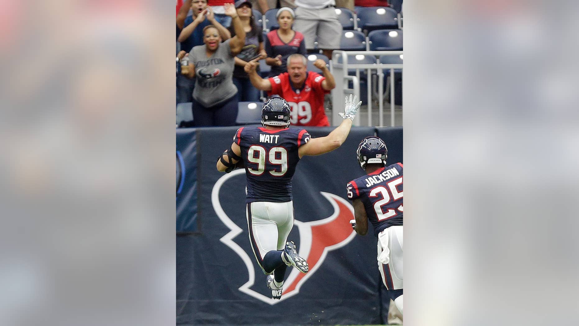 FILE - In this Sept. 28, 2014, file photo, Houston Texans' J.J. Watt (99) celebrates as he returns an interception for a touchdown against the Buffalo Bills during the third quarter of an NFL football game in Houston. The defensive end pretty much has provided enough fodder to fill any list of memorable plays, from top to bottom. (AP Photo/Patric Schneider, File)