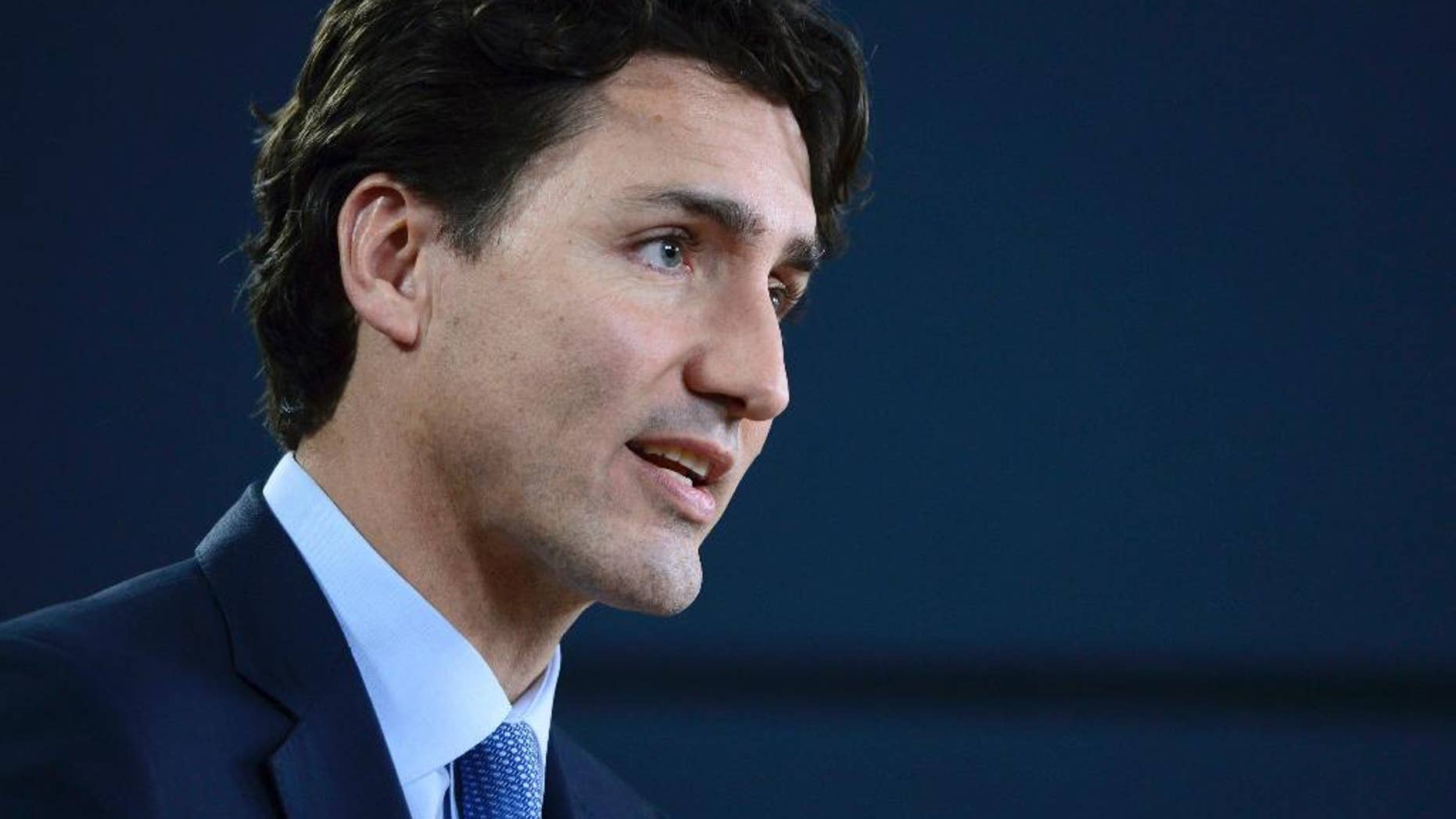 FILE - In this Nov. 29, 2016 file photo, Canada's Prime Minister Justin Trudeau holds a press conference at the National Press Theatre in Ottawa, Ontario. On Monday, Feb. 13, 2017, President Donald Trump will welcome Trudeau to the White House. (Sean Kilpatrick/The Canadian Press via AP, File)