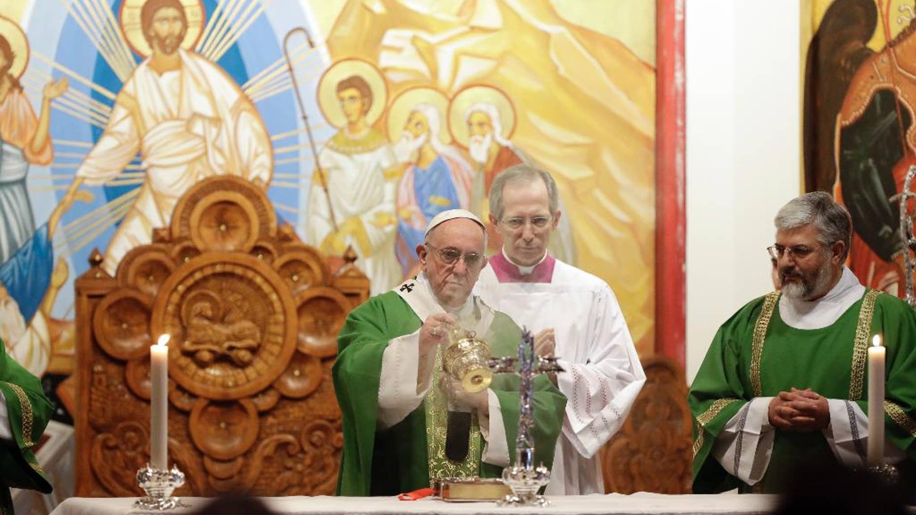 Pope Francis incenses the altar as he celebrates Mass at the St. Mary of Setteville di Guidonia parish church, in the outskirts of Rome, Sunday, Jan. 15, 2017. (AP Photo/Andrew Medichini)