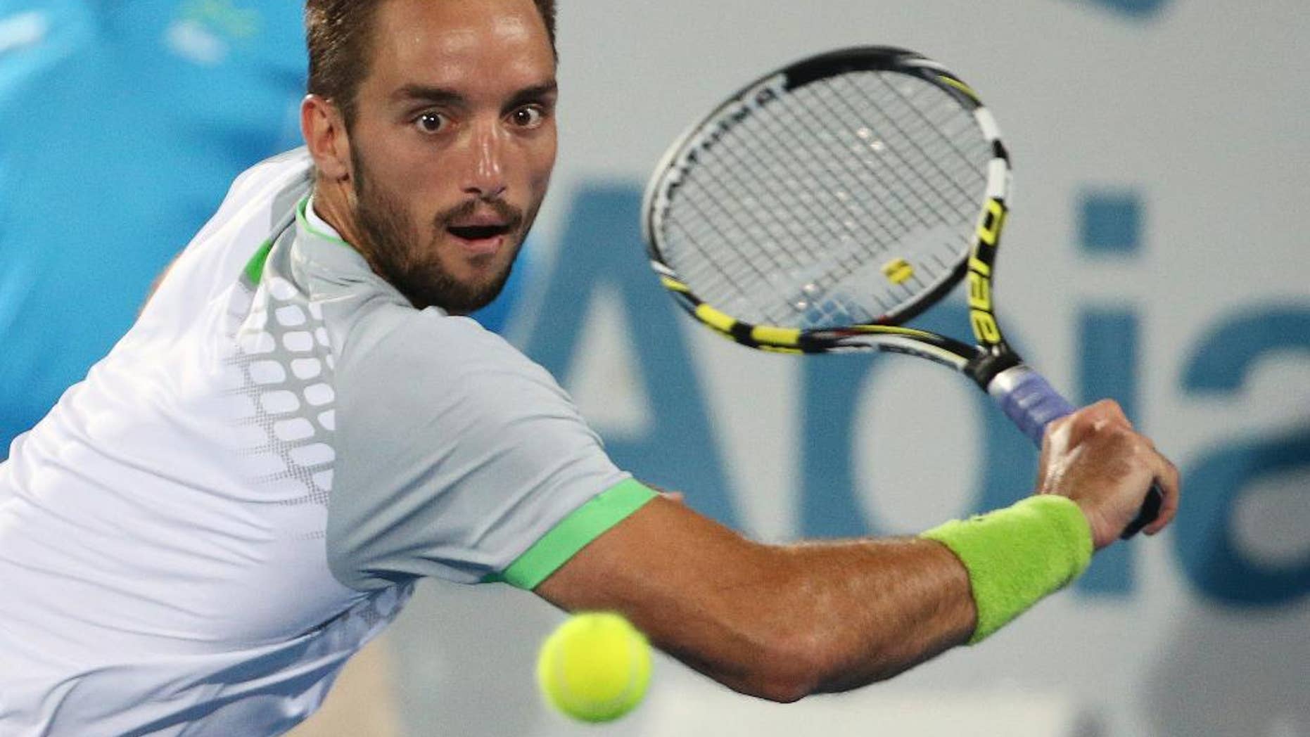 Viktor Troicki of Serbia plays a shot in the men's final against Mikhail Kukushkin of Kazakhstan at the Sydney International Tennis tournament in Sydney, Saturday, Jan. 17, 2015. (AP Photo/Rob Griffith)