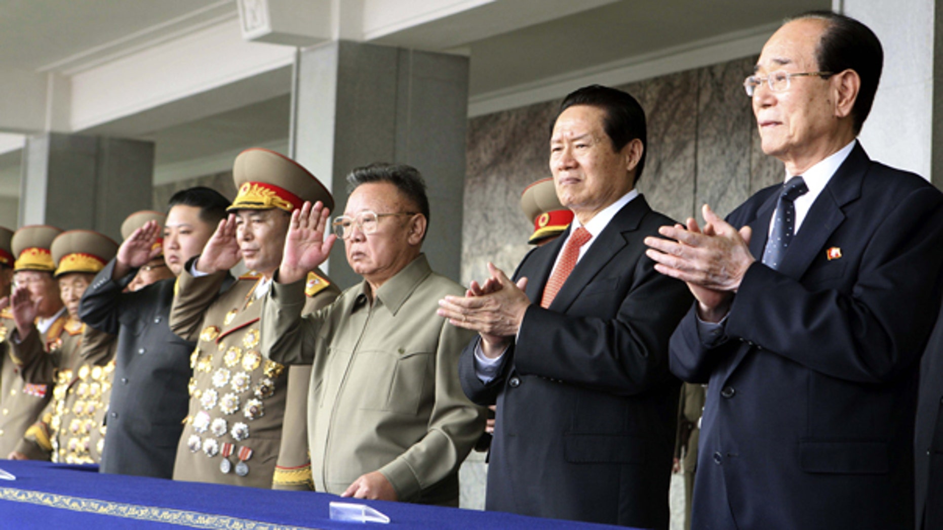 Oct. 10: In this photo released by China's Xinhua News Agency, Kim Jong Un, fourth from left, salutes while standing with his father North Korean leader Kim Jong Il, center and Zhou Yongkang, second from right, a member of the Standing Committee of the Political Bureau of the Communist Party of China (CPC) Central Committee, as they watch a massive military parade to celebrate the 65th anniversary of the founding of the Workers' Party of Korea (WPK), in Pyongyang, North Korea.