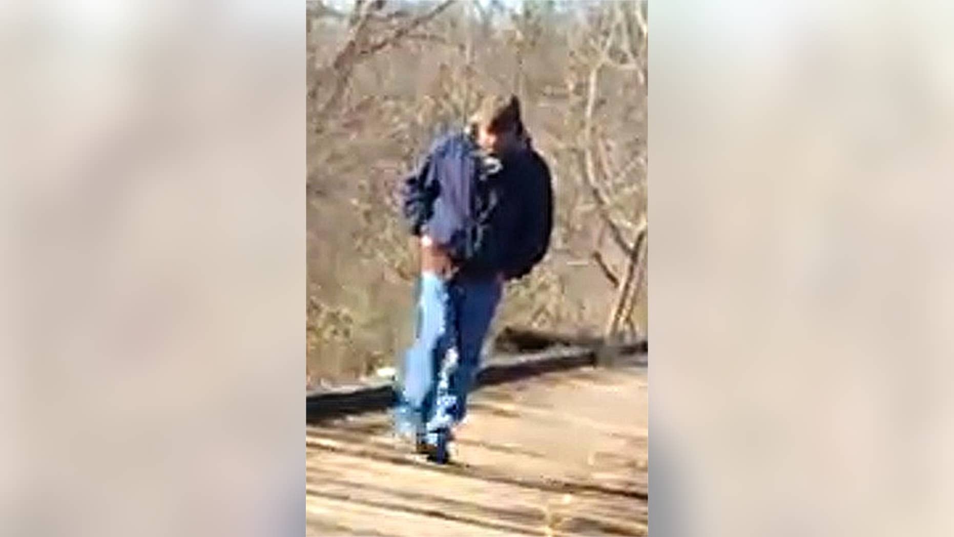 This Feb. 13, 2017, photo released by the Indiana State Police shows a man walking along the trail system in Delphi, Ind. Indiana authorities want to talk to the man in connection with the killings of two teenage girls. He was photographed on the trail system around the time Liberty German and Abigail Williams were dropped off Monday to go hiking. (Indiana State Police via AP)