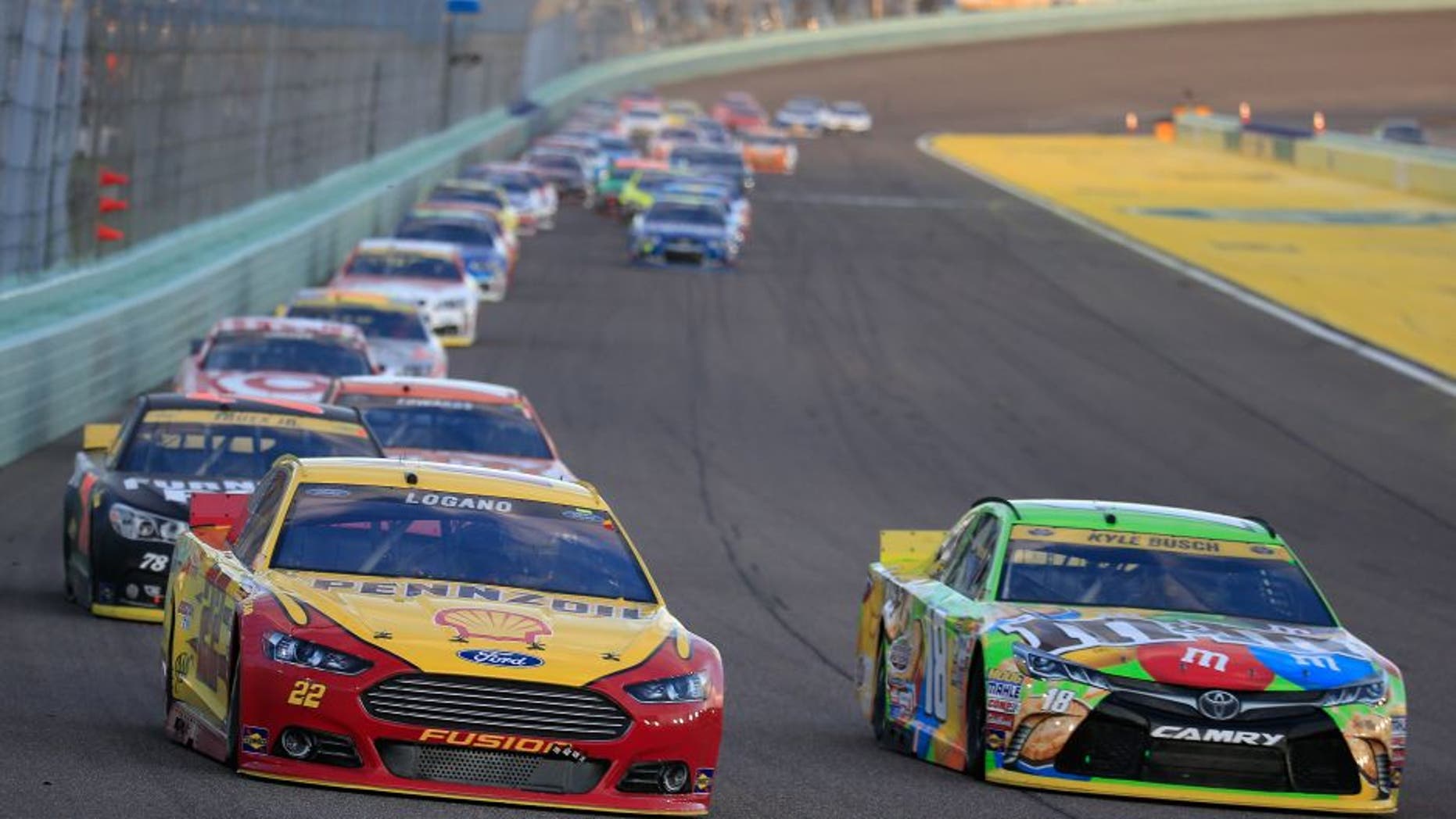 HOMESTEAD, FL - NOVEMBER 22: Joey Logano, driver of the #22 Shell Pennzoil Ford, and Kyle Busch, driver of the #18 M&M's Crispy Toyota, race during the NASCAR Sprint Cup Series Ford EcoBoost 400 at Homestead-Miami Speedway on November 22, 2015 in Homestead, Florida. (Photo by Chris Trotman/NASCAR via Getty Images)