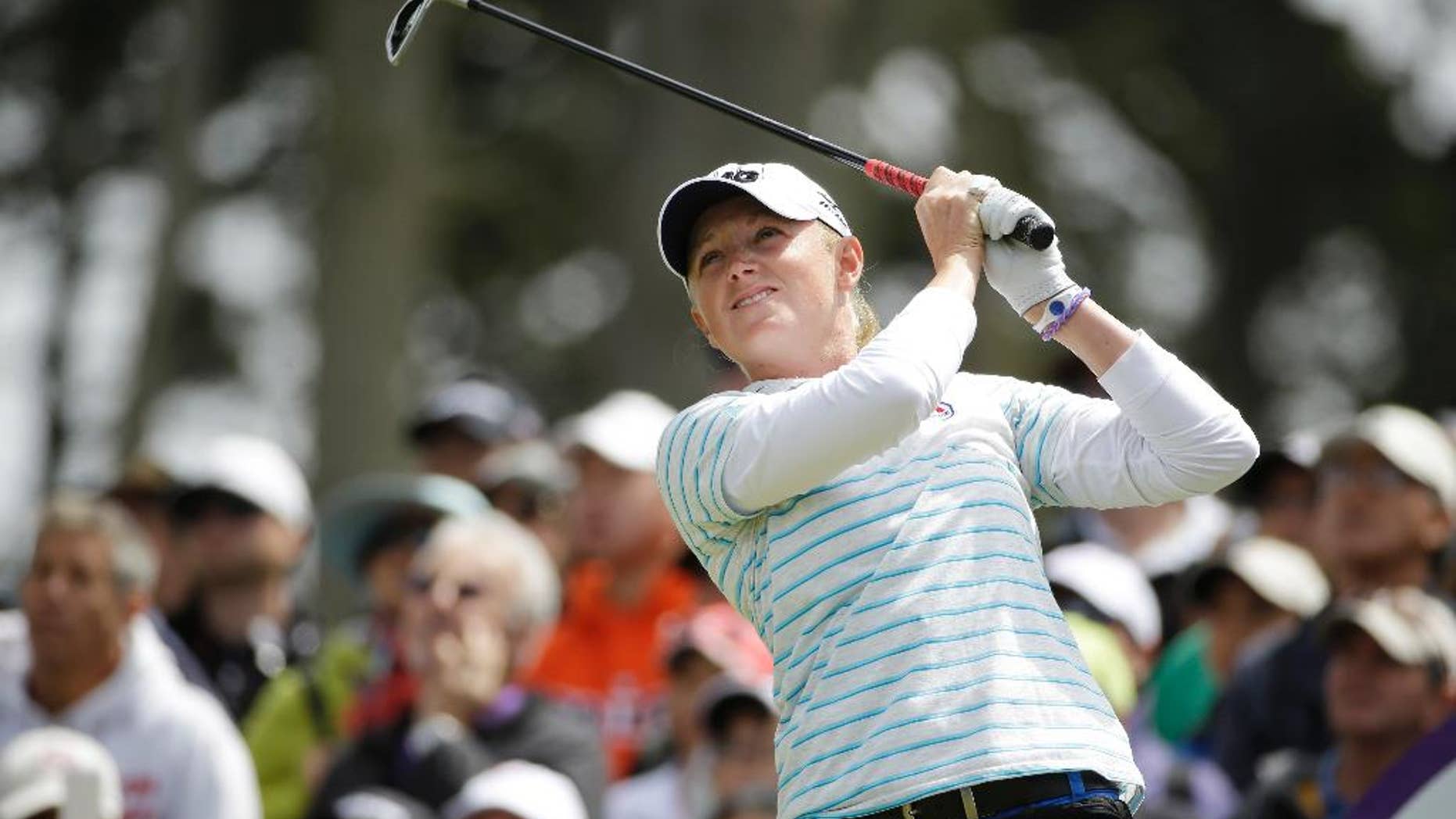 Stacy Lewis follows her shot from the third tee of Lake Merced Golf Club during the final round of the Swinging Skirts LPGA Classic golf tournament on Sunday, April 27, 2014, in Daly City, Calif. (AP Photo/Eric Risberg)