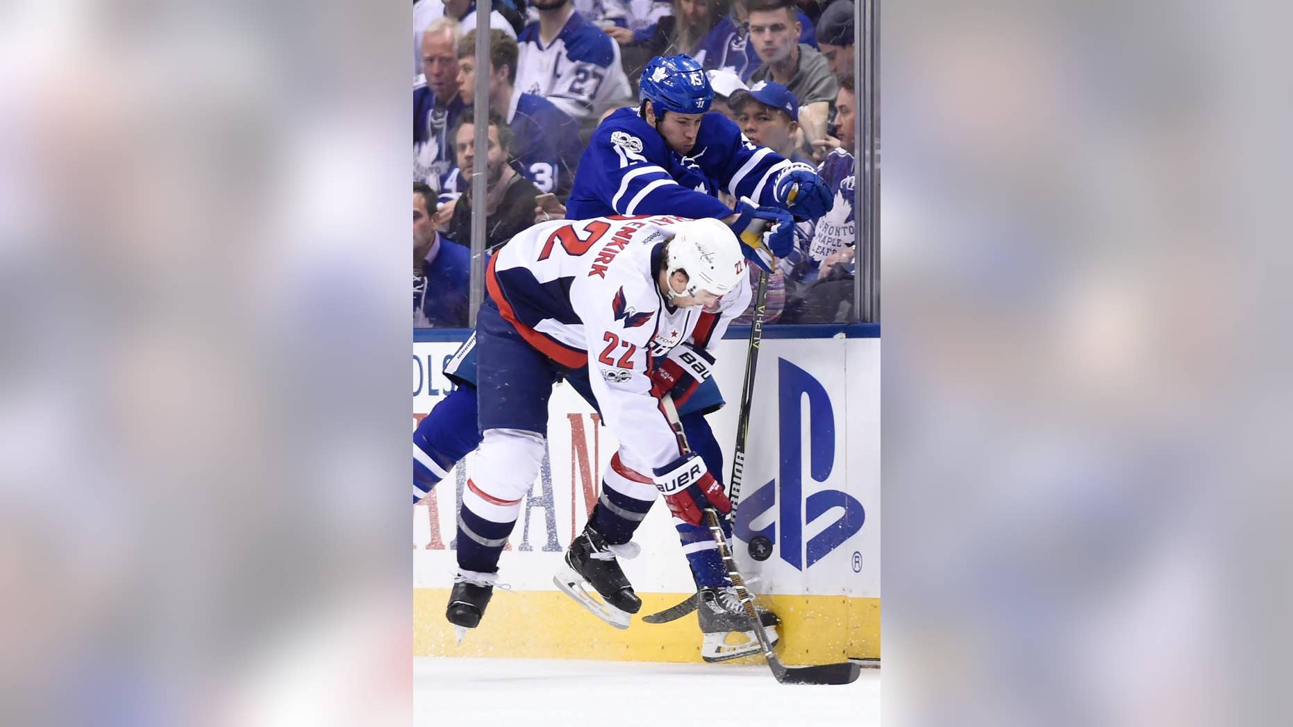 Toronto Maple Leafs left wing Matt Martin (15) hits Washington Capitals defenseman Kevin Shattenkirk (22) during the second period of Game 6 of an NHL hockey Stanley Cup first-round playoff series in Toronto on Sunday, April 23, 2017. (Nathan Denette/The Canadian Press via AP)