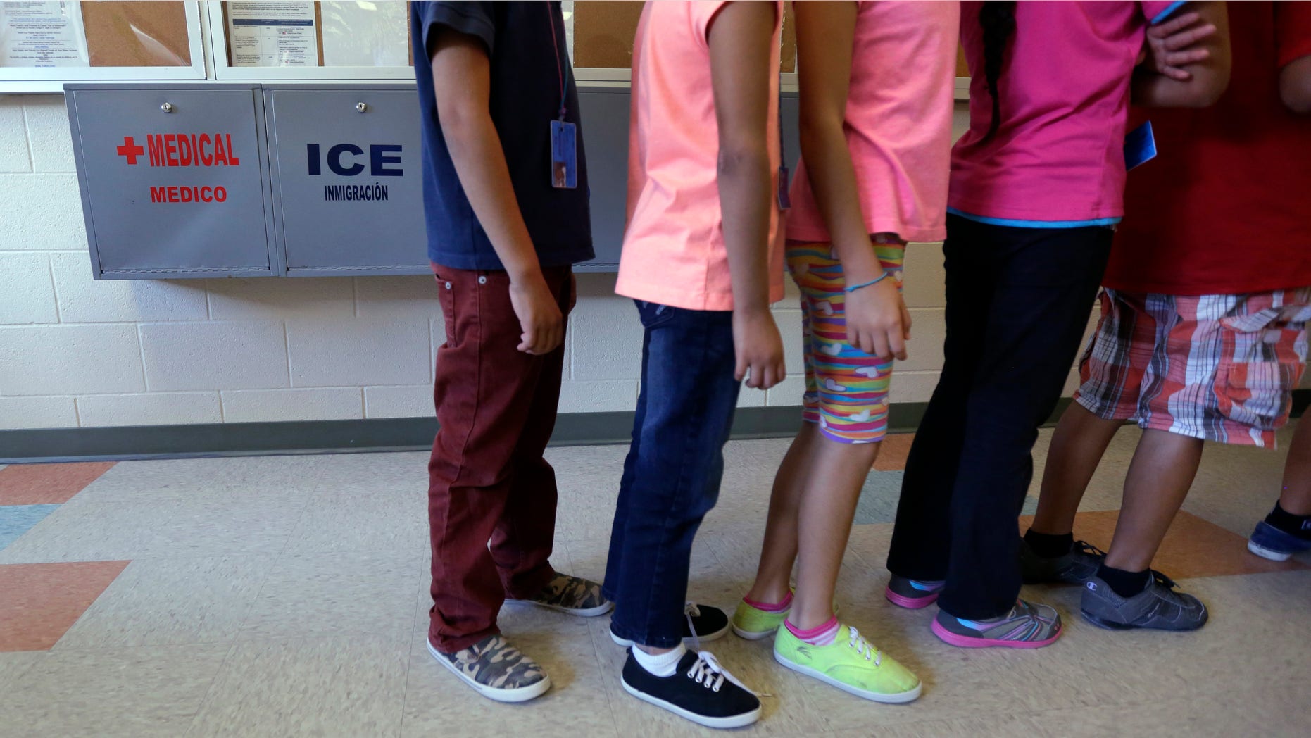 FILE - In this Sept. 10, 2014 file photo, detained immigrant children line up in the cafeteria at the Karnes County Residential Center, a temporary home for immigrant women and children detained at the border, in Karnes City, Texas. Homeland Security Secretary Jeh Johnson says federal officials are making "substantial changes" to end the long-term detention of migrant families who are being held mainly at two large facilities in Texas. (AP Photo/Eric Gay, File)