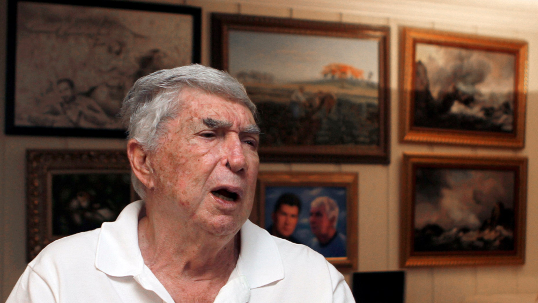 In this photo taken Nov. 8, 2010, Luis Posada Carriles talks to a reporter in Miami. As he prepares for trial Monday, Jan. 10, 2011 in El Paso, Texas, on federal charges connected to the decade-old bombings that killed an Italian tourist, Posada's art says much about the cagey former CIA asset who remains a lightning rod in much of Latin America. (AP Photo/Alan Diaz)