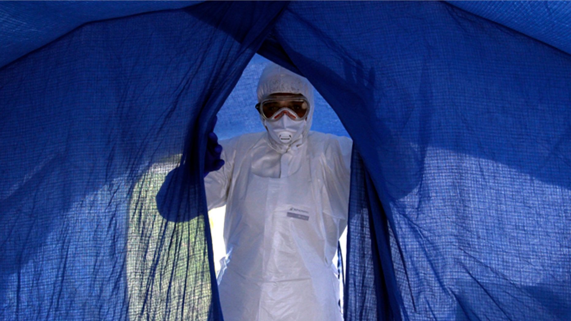 In this Sept. 24, 2014 photo, nurse Dalila Martinez, trainer of the Cuban medical team to travel to Sierra Leone, enters a tent during a practice drill at a training camp, in Havana, Cuba. Cuba's health ministry is sending more than 160 health workers to help stop the raging Ebola outbreak in Sierra Leone in early October. They will stay for six months. (AP Photo/Ladyrene Perez, Cubadebate)