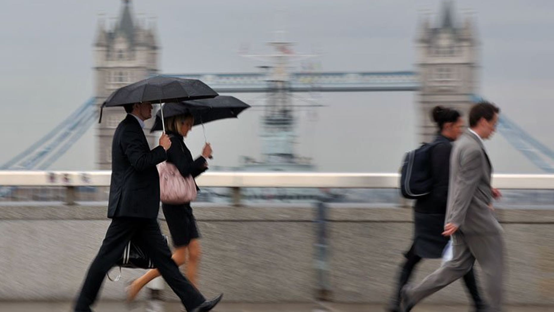 City workers walk over London Bridge. London shares closed in negative territory on Monday with high gold prices offering traders some support while a string of uneven US earnings fuelled investor caution over economic activity, dealers said.