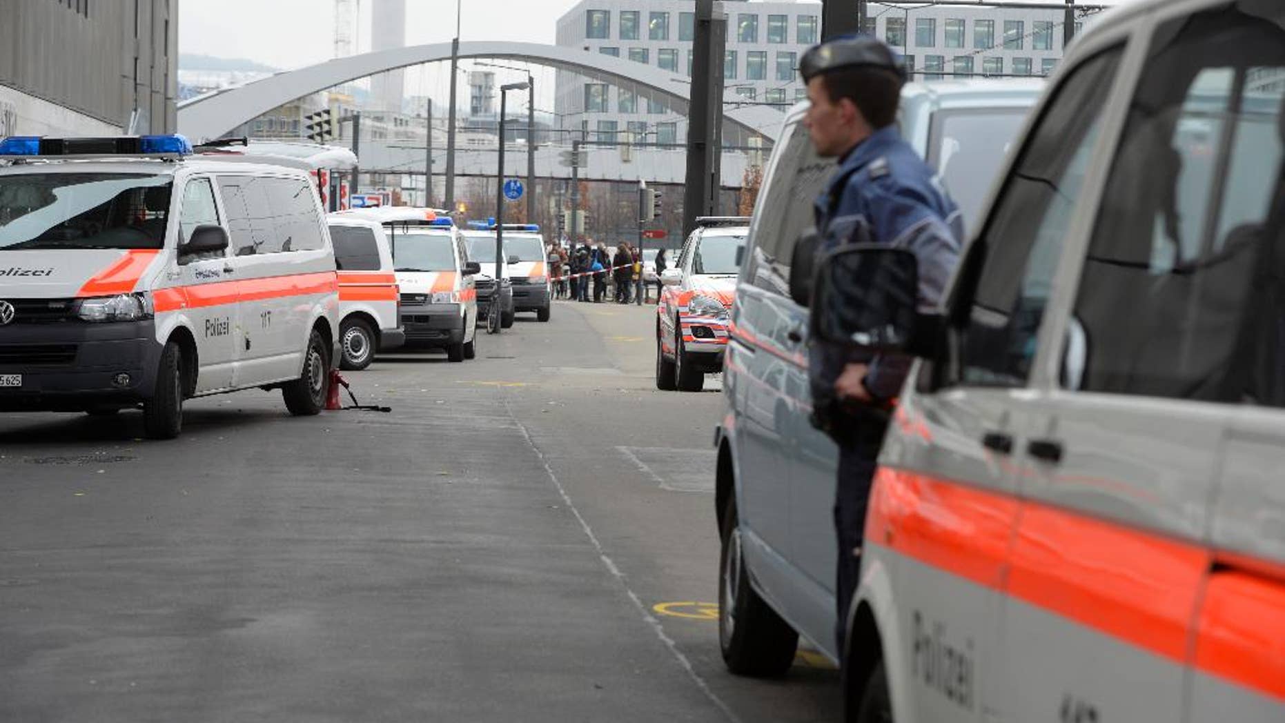 Police cars wait outside the Zurich, Switzerland, university of art Thursday morning Dec. 4, 2014 after an alarm was given. Police wasn't able to immediately give the reason for the alarm. (AP Photo/Keystone, Walter Bieri)