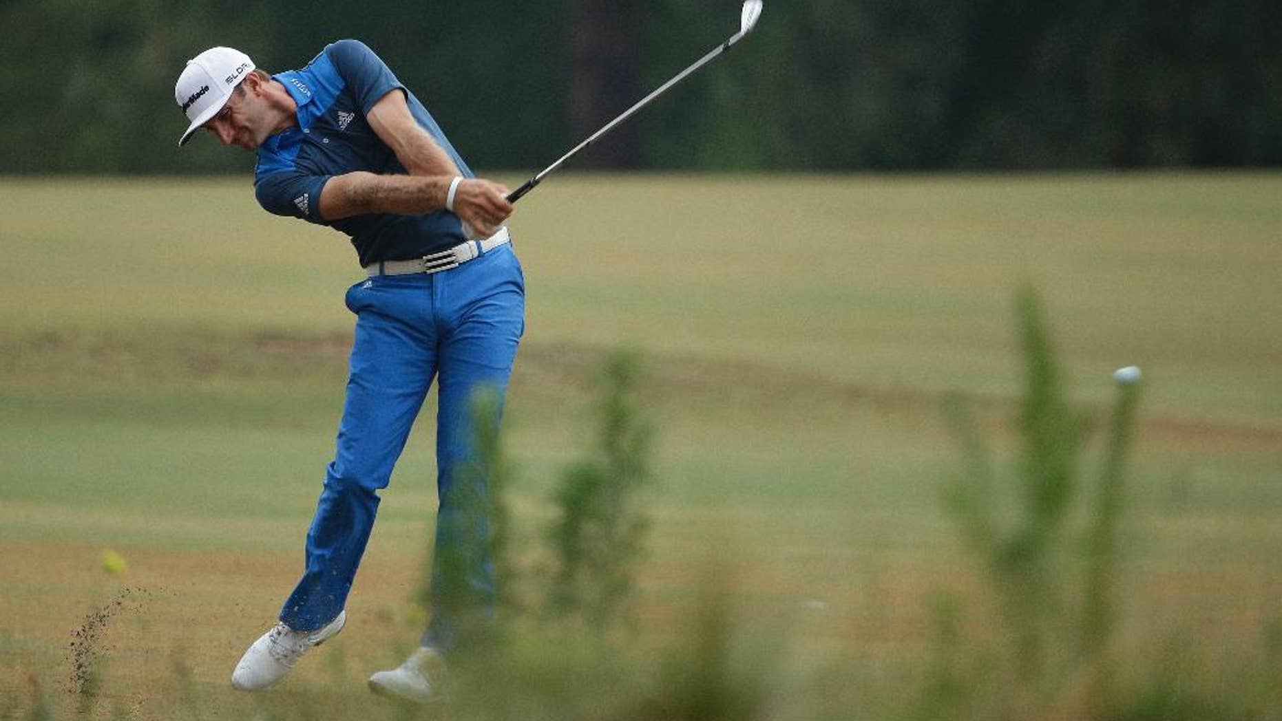 Dustin Johnson hits from the fairway on the 10th hole during the second round of the U.S. Open golf tournament in Pinehurst, N.C., Friday, June 13, 2014. (AP Photo/Chuck Burton)