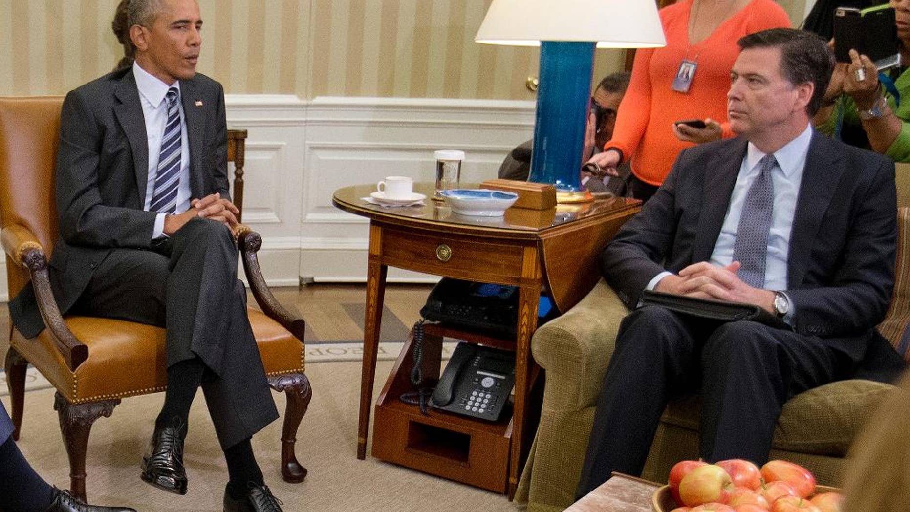 FBI Director James Comey, right, listens to President Barack Obama, left, speak to members of the media in the Oval Office of the White House in Washington, Monday, June 13, 2016, after receiving an update on the massacre at an Orlando nightclub. Comey says the gunman in the Orlando nightclub attack that killed 49 people had "strong indications of radicalization" and was likely inspired by foreign terrorist organizations. (AP Photo/Pablo Martinez Monsivais)