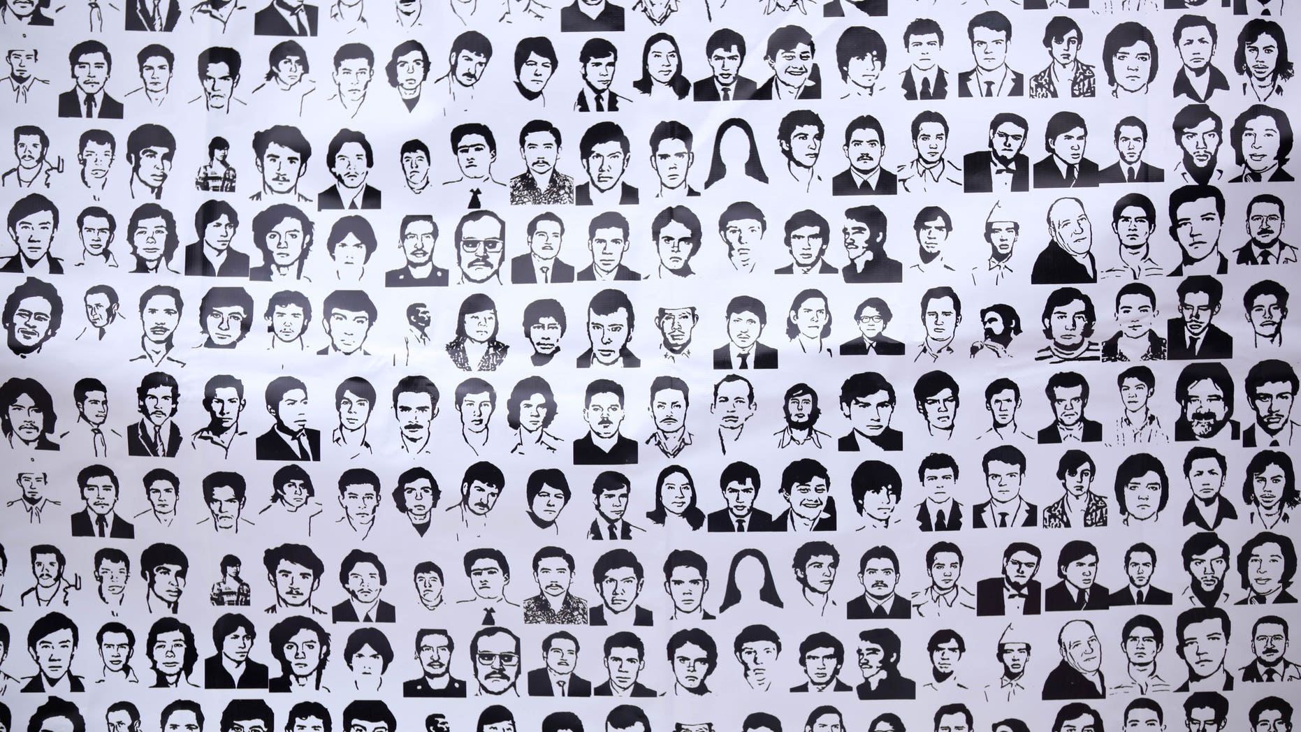 FILE - In this May 10, 2012, file photo, a banner shows ink drawings of missing people at the National March for Dignity on the day Mexicans celebrate el Dia de La Madre, or Mother's Day, in Mexico City. Propuesta Civica, or Civic Proposal, a civic organization released on its website on Thursday, Dec. 20, 2012, a database, allegedly collected by the federal Attorney General's Office, it says contains official information on more than 20,000 people who have disappeared in Mexico over the past six years. (AP Photo/Alexandre Meneghini, file)