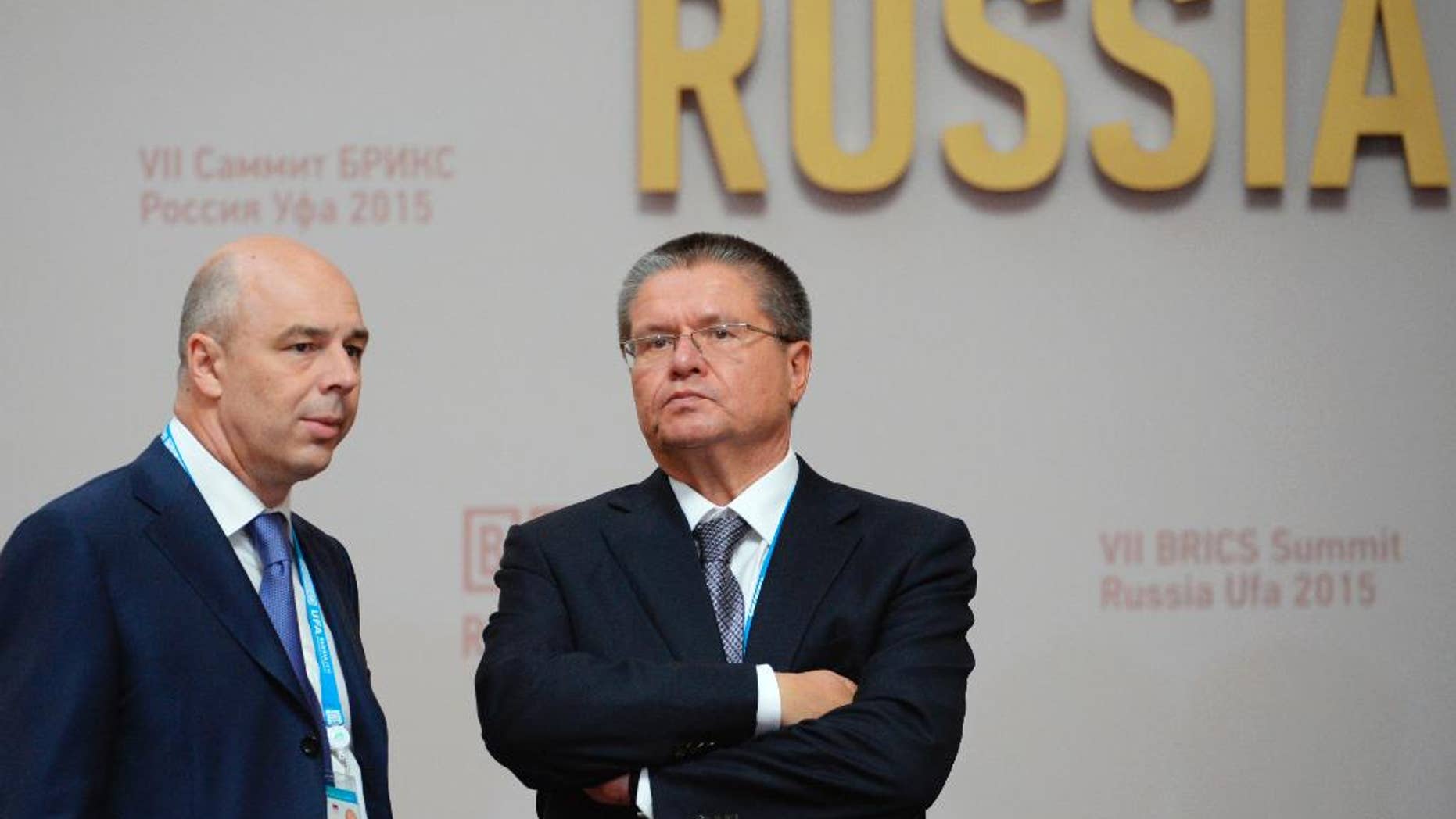 FILE - In this file photo taken on Thursday, July 9, 2015, Anton Siluanov, left, Minister of Finance of the Russian Federation, and Alexey Ulyukayev, Minister of Economic Development of the Russian Federation speak in Ufa, Russia. A long-serving Russian minister has been detained over an alleged $2 million bribe, the most senior government official to face corruption charges in a quarter-century. (Government Pool Photo via AP, File)