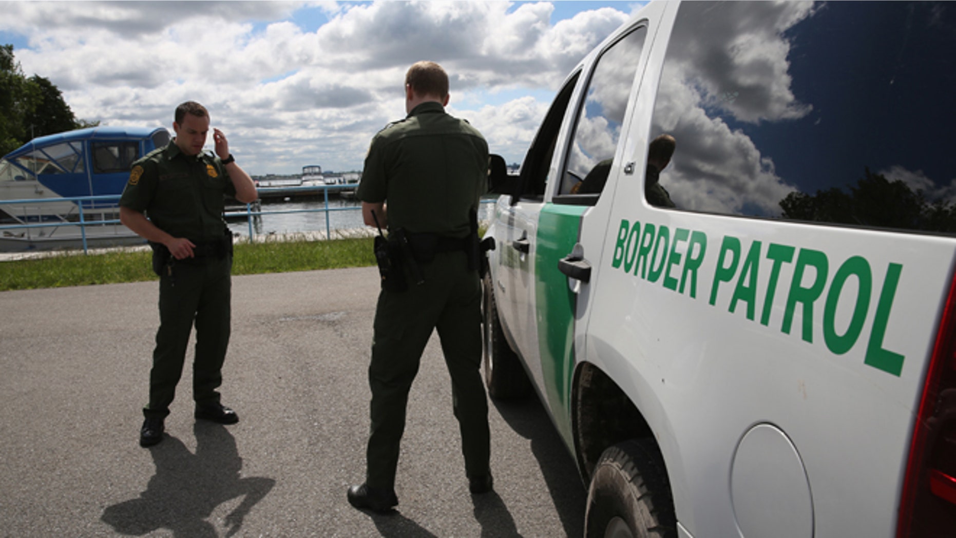 BEAVER ISLAND STATE PARK, NY - JUNE 03: U.S. Border Patrol agents talk while at a marina on the Niagara River at the U.S.-Canada border on June 3, 2013 in Beaver Island State Park, New York. U.S. Customs and Border Protection, which includes the Border Patrol, monitors the 5,525 mile long border, including Alaska, forming the longest international border between two countries in the world. (Photo by John Moore/Getty Images)