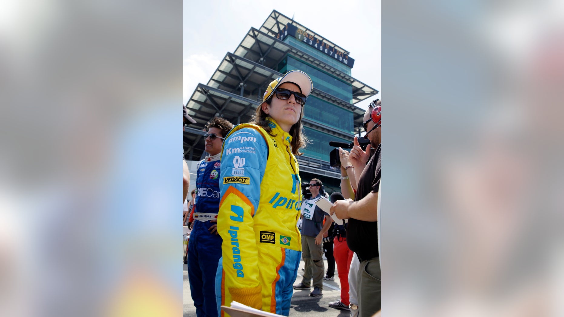In this photo taken on Sunday, May 19, 2013, Ana Beatriz, of Brazil, stands in the pits after the second day of qualifications for the Indianapolis 500 auto race at the Indianapolis Motor Speedway in Indianapolis. Beatriz is one of four women starting Sunday's race. (AP Photo/Tom Strattman)