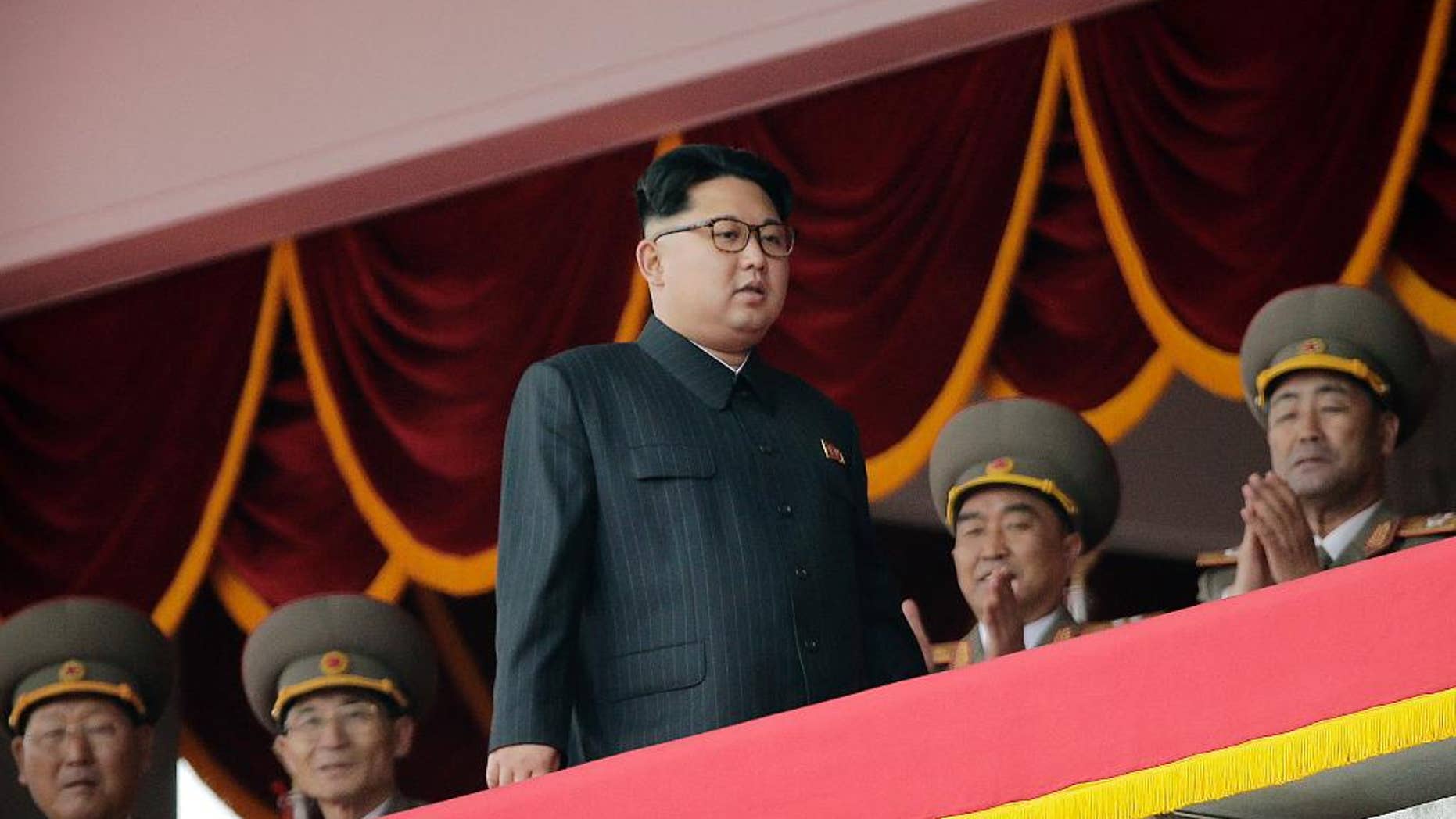 North Korean leader Kim Jong Un, center, watches parade participants from a balcony at the Kim Il Sung Square on Tuesday, May 10, 2016, in Pyongyang, North Korea. Hundreds of thousands of North Koreans celebrated the country's newly completed ruling-party congress with a massive civilian parade featuring floats bearing patriotic slogans and marchers with flags and pompoms. (AP Photo/Wong Maye-E)
