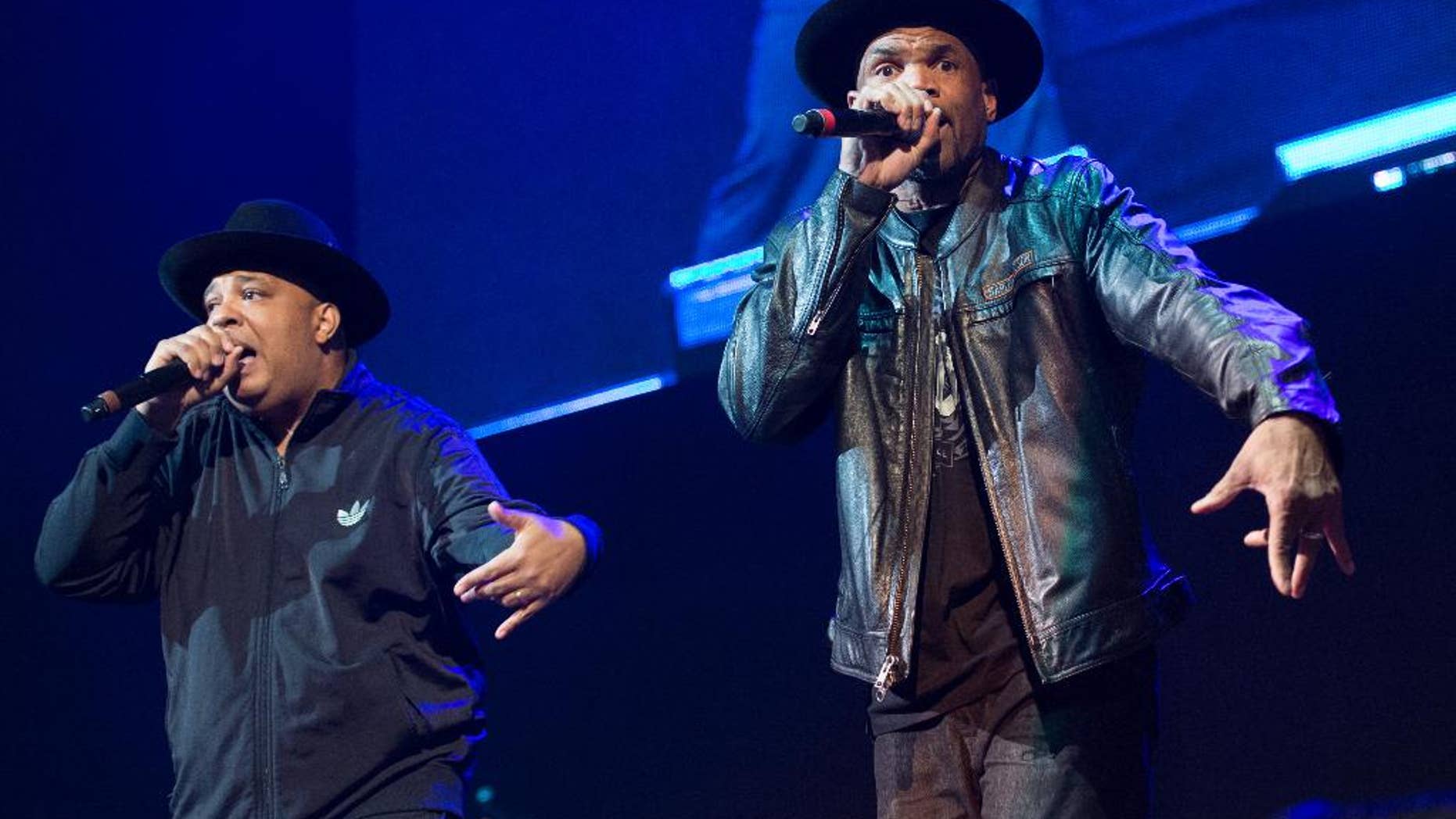 FILE - In this Dec. 19, 2014 file photo, Joseph Simmons, left, and Darryl McDaniels of Run DMC perform at Christmas in Brooklyn at the Barclays Center in the Brooklyn borough of New York. Run DMC is expected to open for the Red Hot Chili Peppers at the sixth-annual DirecTV Super Saturday Night concert in San Francisco the night before the Super Bowl. (Photo by Scott Roth/Invision/AP, File)