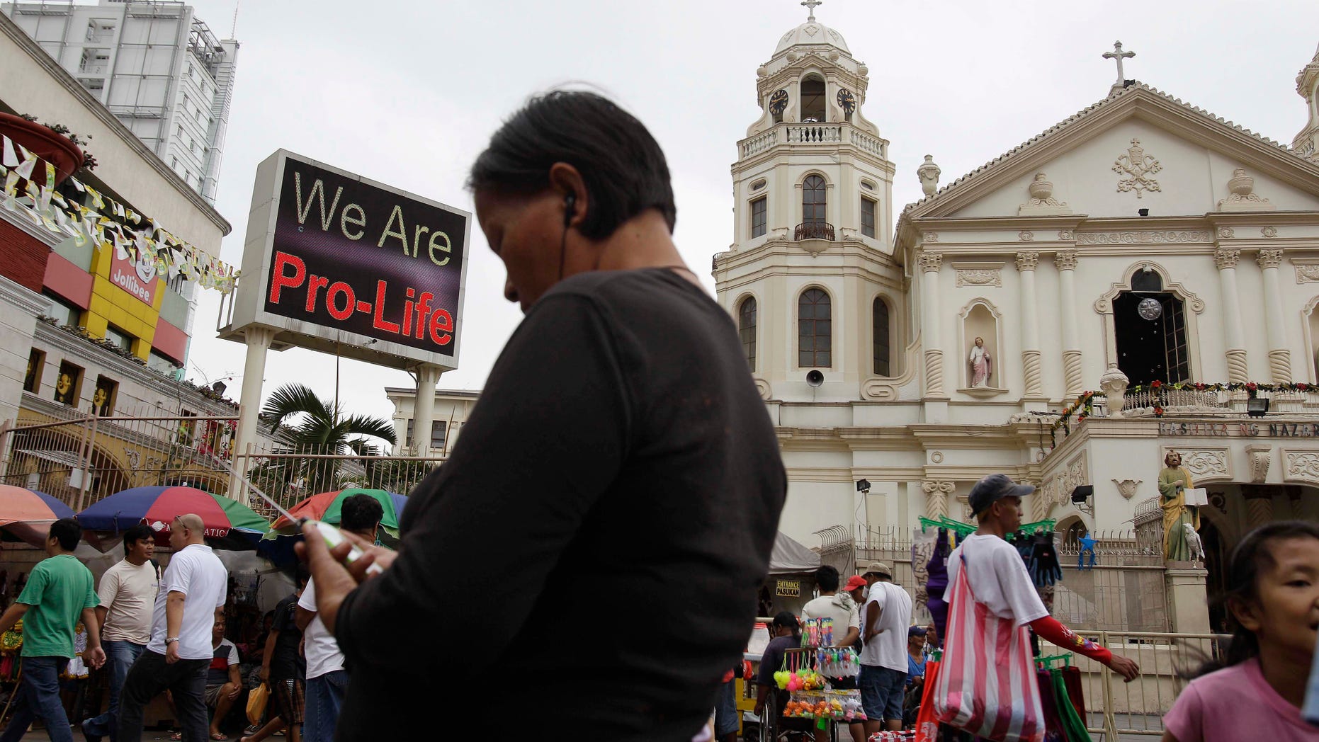 A "Pro-Life" sign flashes on an electric signboard outside the Roman Catholic Minor Basilica of the Black Nazarene in downtown Manila, Philippines on Thursday, Jan. 3, 2013. Philippine President Benigno Aquino III last month signed the Responsible Parenthood and Reproductive Health Act of 2012. The law that provides state funding for contraceptives for the poor pitted the dominant Roman Catholic Church in an epic battle against the popular Aquino and his followers. (AP Photo/Aaron Favila)