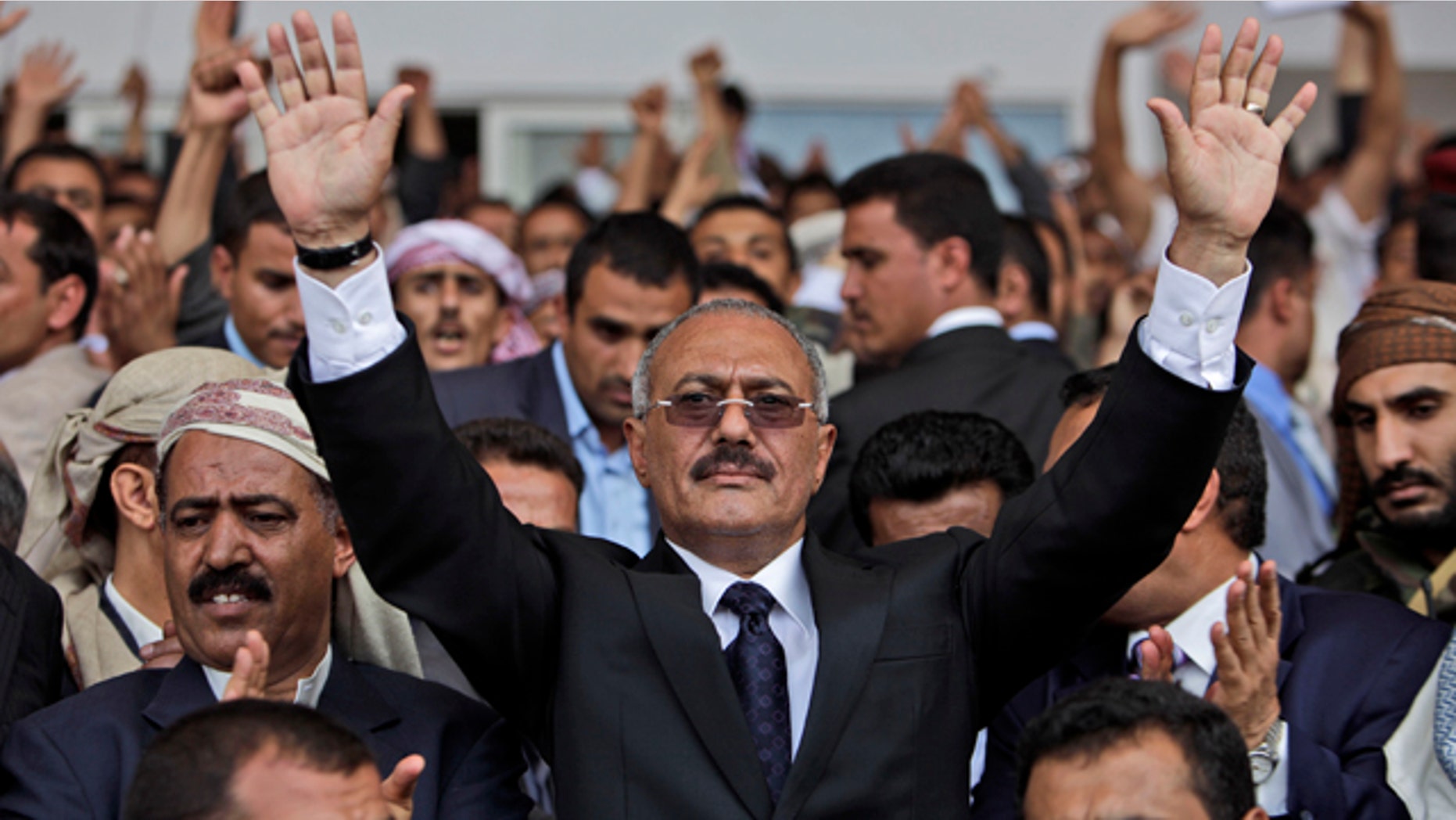 April 15: Yemeni President Ali Abdullah Saleh waves to his supporters during a rally in Sanaa, Yemen.
