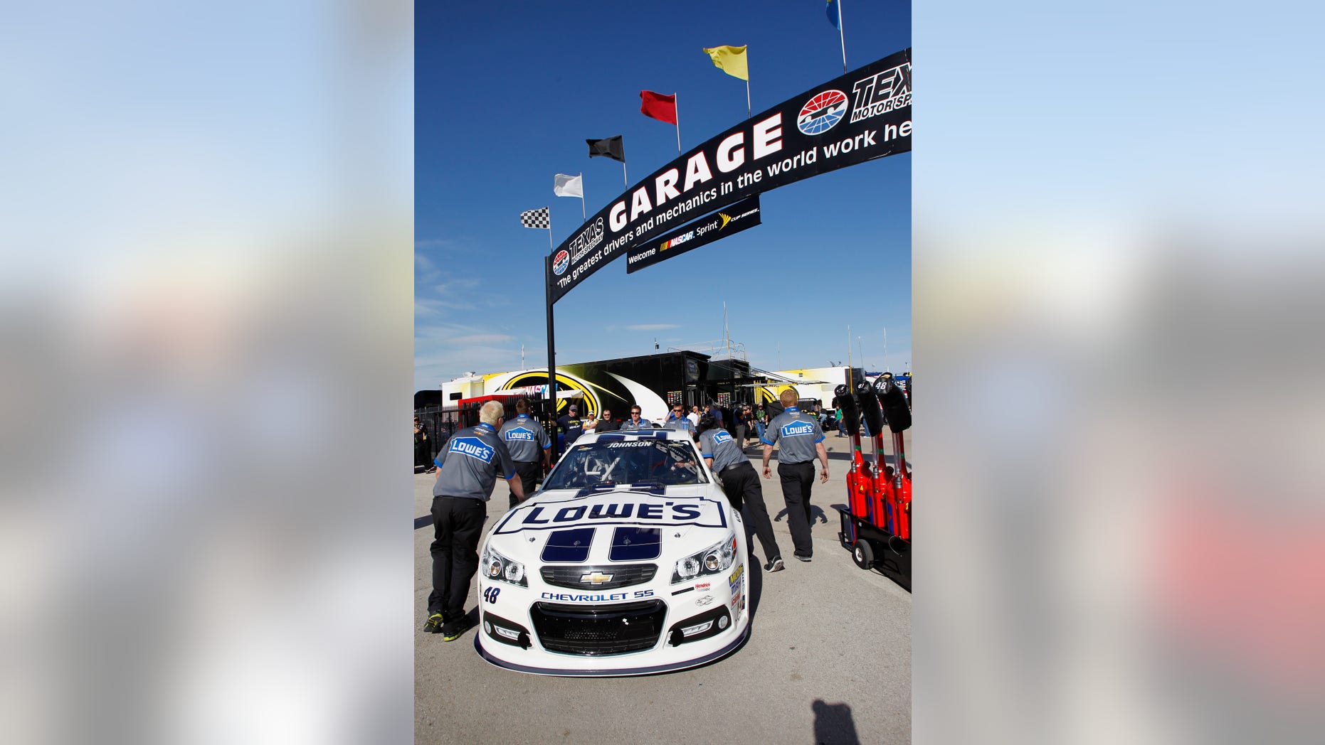Jimmie Johnson's car is pushed to the garage before the NASCAR Sprint Cup series NRA 500 auto race at Texas Motor Speedway, Saturday, April 13, 2013, in Fort Worth, Texas. (AP Photo/Tim Sharp)