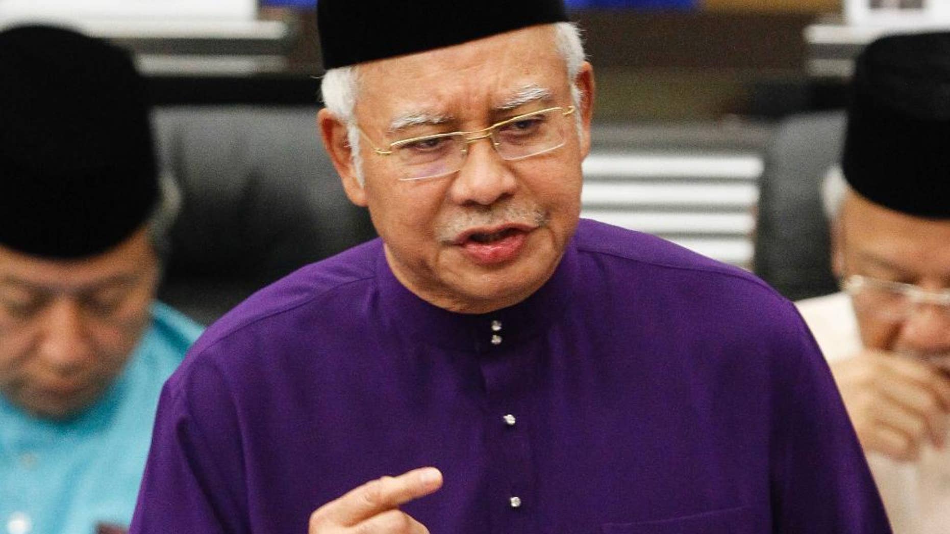 FILE - In this Oct. 23, 2015 file photo, Malaysian Prime Minister and Finance Minister Najib Razak speaks as he unveils the Malaysia's 2016 budget at Parliament House in Kuala Lumpur, Malaysia. Scandal-ridden Najib is seeking a big win for his ruling coalition in elections in the country's biggest state. More than 1.1 million people in Sarawak state on Borneo island are voting Saturday, May 7, 2016, for 82 lawmakers in the state assembly. (AP Photo/Joshua Paul, File)