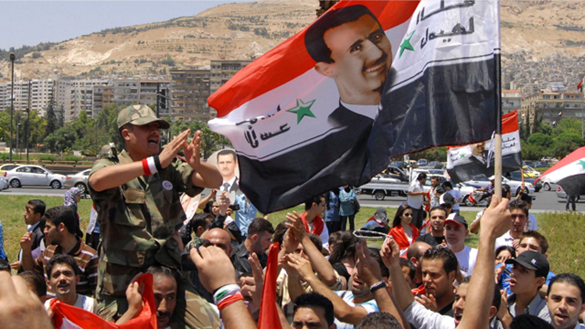 June 20: Pro-Syrian regime protesters shout President Bashar Assad slogans after he delivered a speech, in Damascus, Syria.