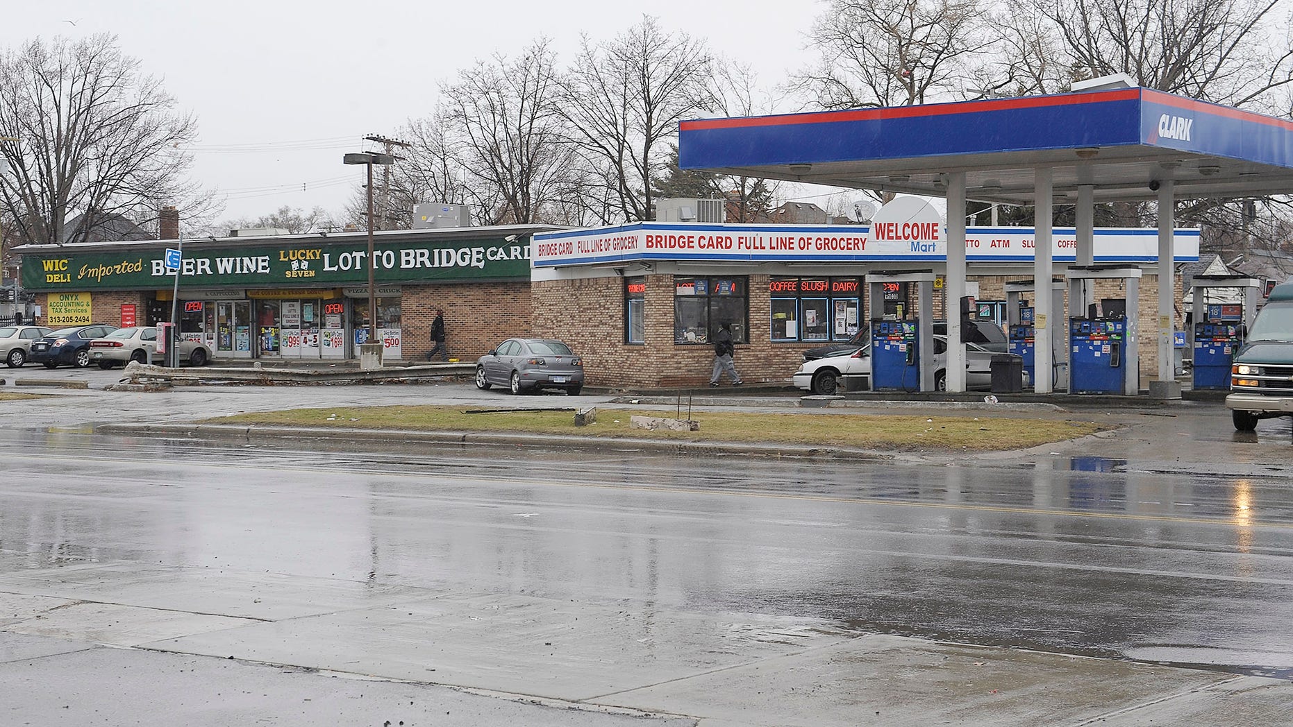 April 3, 2014: Cars enter local business at the scene of an attack on Wednesday at the street corners of Morang and Balfour in Detroit.