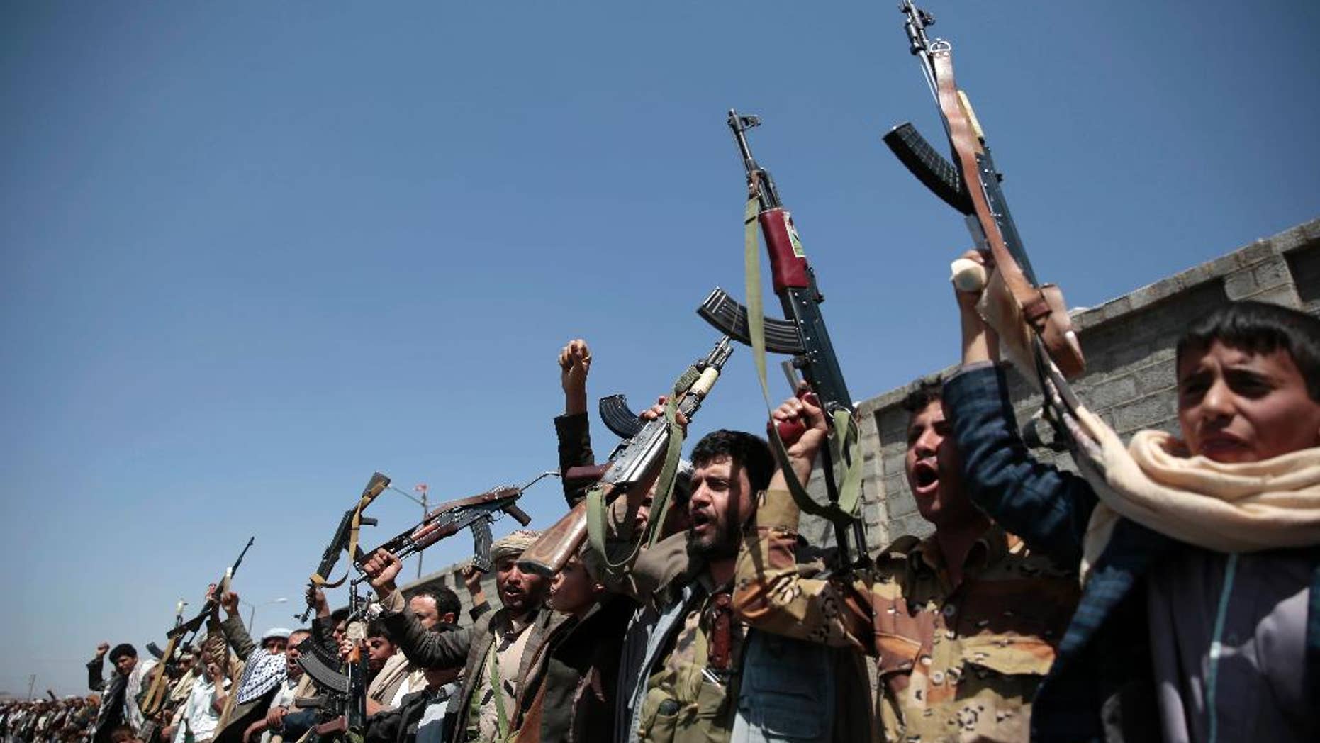 FILE - In this Oct. 2, 2016 file photo, tribesmen loyal to Houthi rebels, hold their weapons as they chant slogans during a gathering aimed at mobilizing more fighters into battlefronts in several Yemeni cities, in Sanaa, Yemen. The U.S. is weighing what military response it should take against Yemen-based Houthi rebels, who U.S. officials say launched two missiles at American warships in the Red Sea on Sunday, the Pentagon said Tuesday, Oct. 11, 2016. (AP Photo/Hani Mohammed, File)