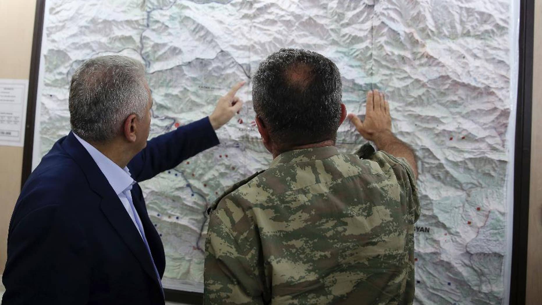 Turkey's Prime Minister Binali Yildirim, left, examining a Turkey-Iraq border map with an army commander Sept. 5.
