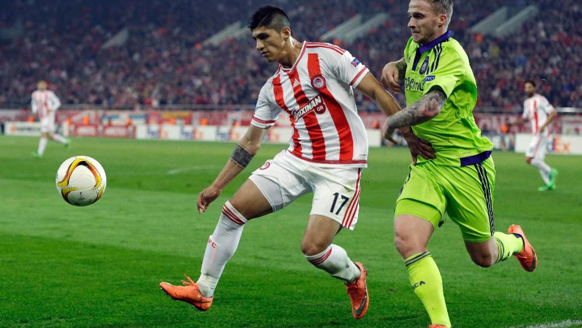 Feb. 25, 2016: Olympiakos' Alan Pulido, left, fights for the ball with Anderlecht's Alexander Buttner during the Europa League round of 32 soccer match at the Georgios Karaiskakis stadium in the port of Piraeus, Greece.
