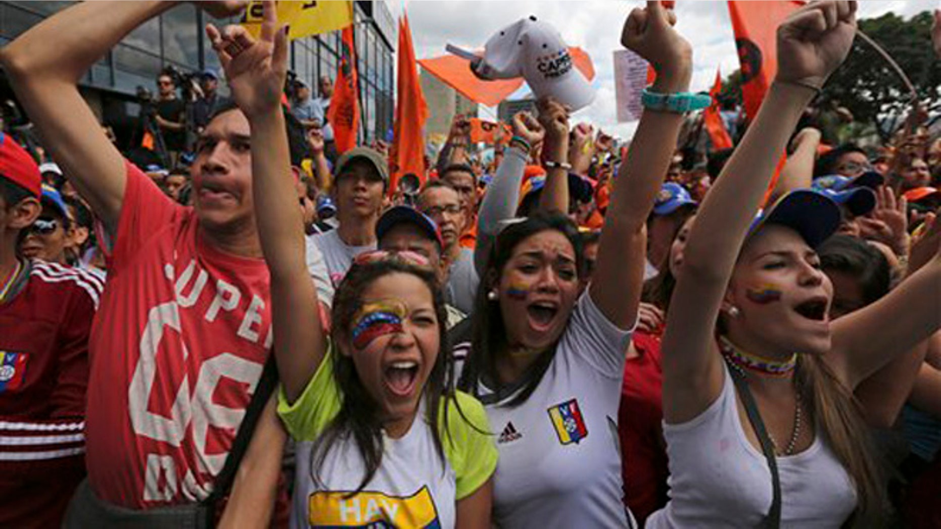 Supporters of opposition leader Henrique Capriles greet him upon his arrival to lead a protest against Venezuela's President Nicolas Maduro in Caracas, Venezuela, Saturday, Nov. 23, 2013. Thousands of Maduro opponents took to the streets on Saturday to express outrage over the countryÃs deepening economic crisis, seeking to rebuild momentum sapped after a string of electoral defeats. (AP Photo/Fernando Llano)
