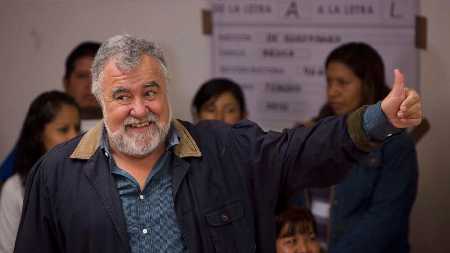 Alejandro Encinas, candidate for governor of the state of Mexico for the Democratic Revolutionary Party (PRD), shows his ink-stained thumb after casting his vote at a polling station in Texcoco, Mexico, Sunday July 3, 2011. There's more at stake than picking a governor as voters go to the polls Sunday in the state of Mexico, with 15 million people the country's most populous state and a bellwether for next year's presidential election. (AP Photo/Moises Castillo)