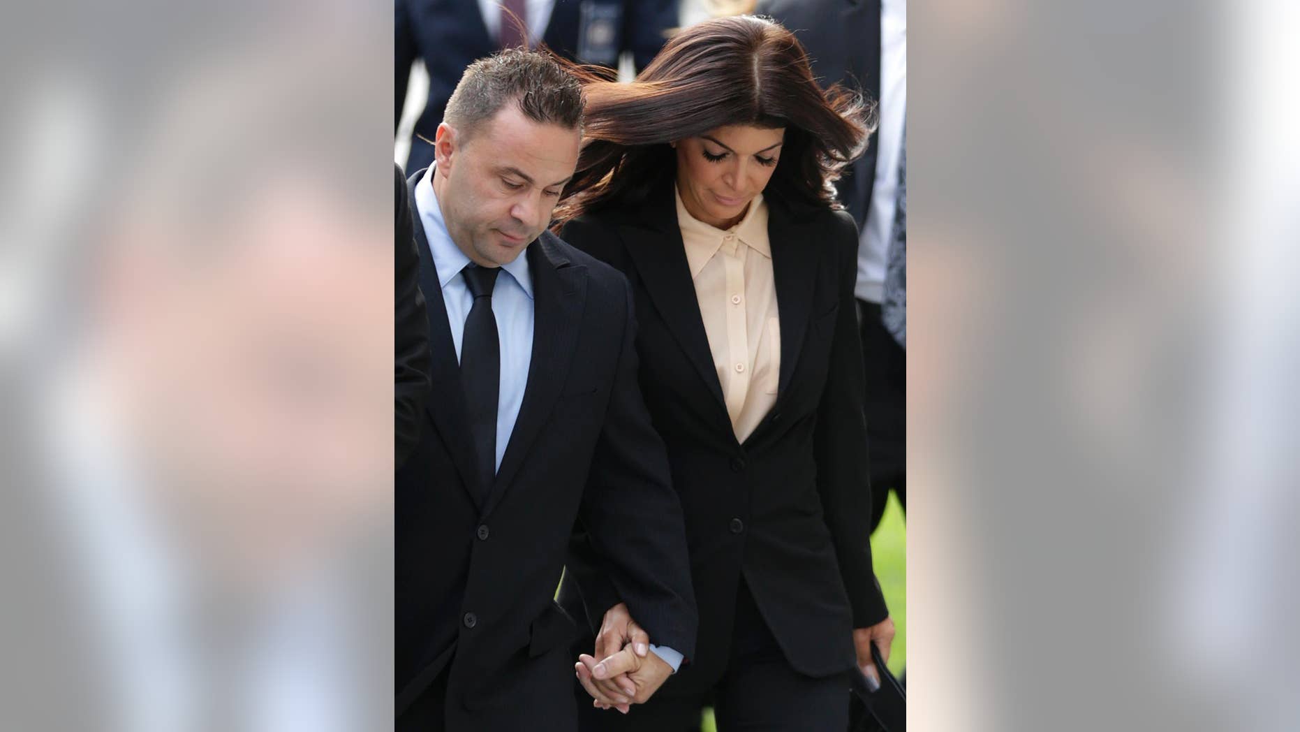 FILE- In this Oct. 2, 2014 file photo, "The Real Housewives of New Jersey" stars Teresa Giudice, and her husband Giuseppe "Joe" Giudice, left, of Montville Township, N.J., walk toward Martin Luther King Jr. Courthouse for a court appearance on federal conspiracy and bankruptcy fraud charges in Newark, N.J. An attorney for Joe Giudice said the husband of Teresa Giudice, is expected to report to the Fort Dix federal prison on Wednesday, March 23, 2016, to begin serving a 41-month sentence for bankruptcy fraud. (AP Photo/Julio Cortez, File)