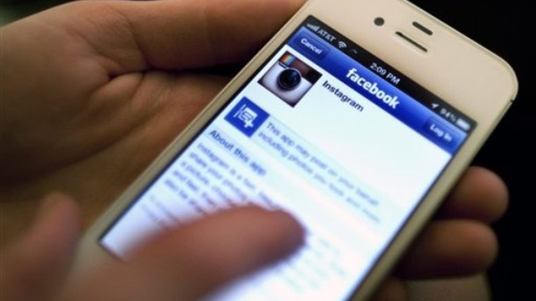 An Instagram photo is shared with Facebook on an iPhone.