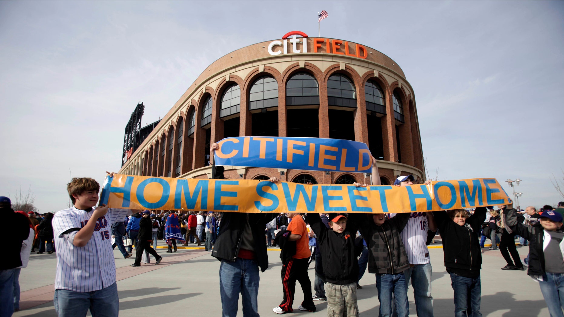 FILE - In this April 13, 2009, file photo, baseball fans hold up a sign in front of the Citi Field before the New York Mets' home-opening baseball game against the San Diego Padres at Citi Field in New York. A person familiar with the announcement says Major League Baseball will announce Wednesday, May 16, 2012, that the Mets will host the 2013 All-Star game at Citi Field. The person spoke on condition of anonymity on Tuesday, May 15, because MLB did not reveal the purpose of Wednesday's news conference at City Hall in New York. (AP Photo/Seth Wenig, File)