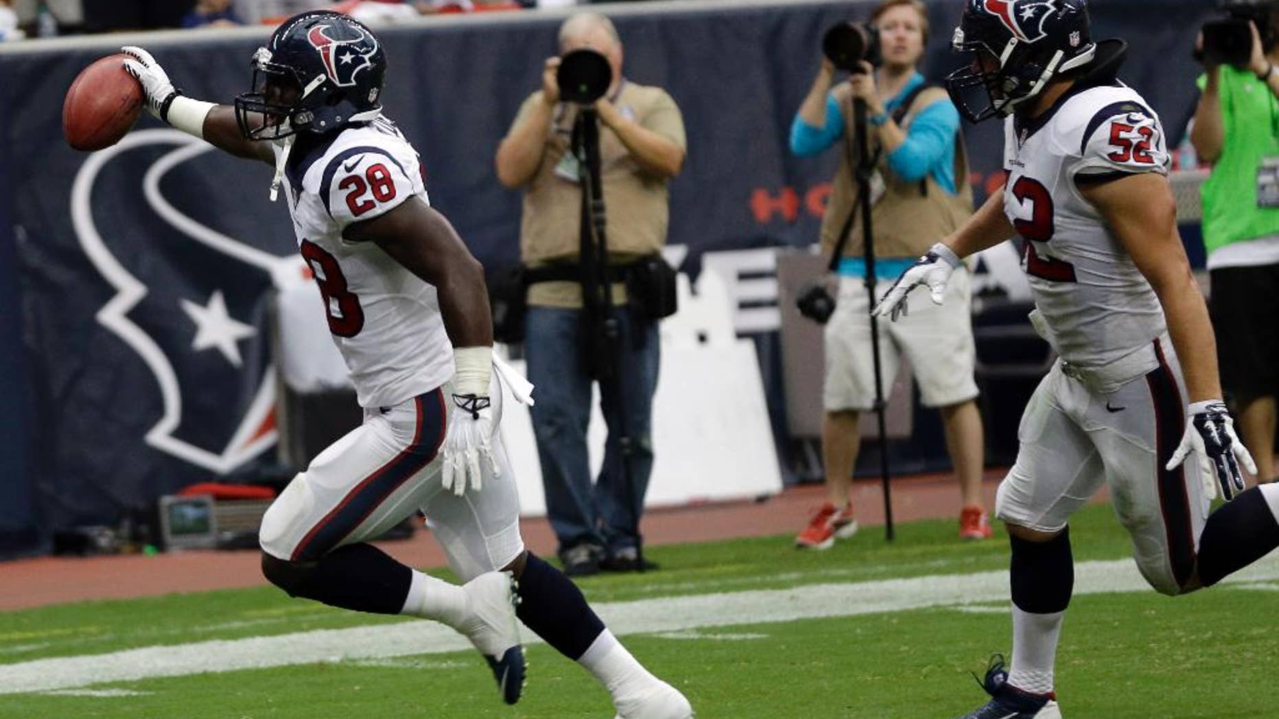 Houston Texans' Alfred Blue (28) scores against the Washington Redskins on a blocked punt during the second quarter of an NFL football game Sunday, Sept. 7, 2014, in Houston. (AP Photo/David J. Phillip)