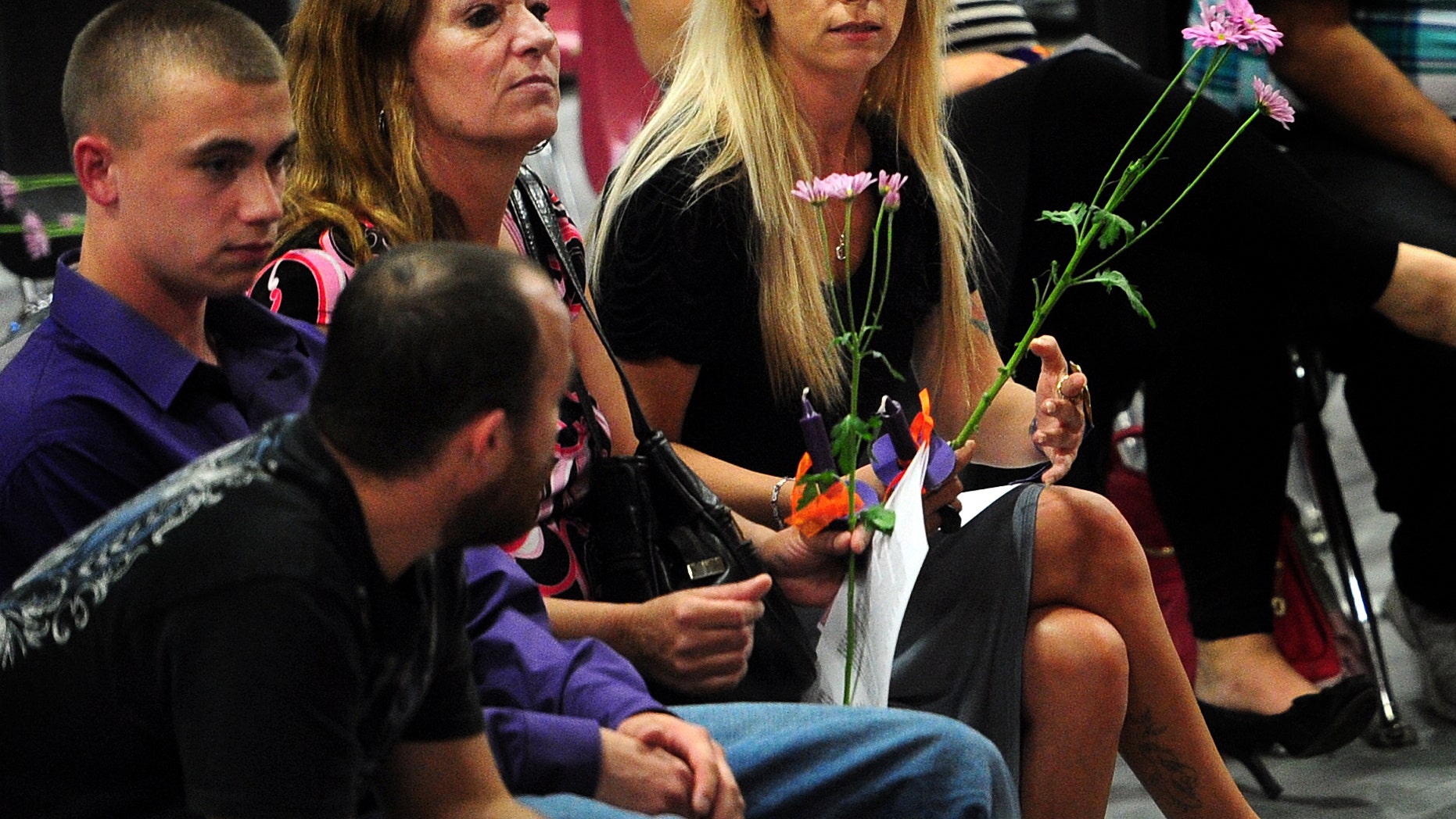 Family members of Hailey Darlene Dunn, including her mother, Billie Jean Dunn, right, grieve the teenager's loss during a public memorial service Sunday at Colorado Middle School in Colorado City, Texas. (AP Photo/The Abilene Reporter-News, Joy Lewis)