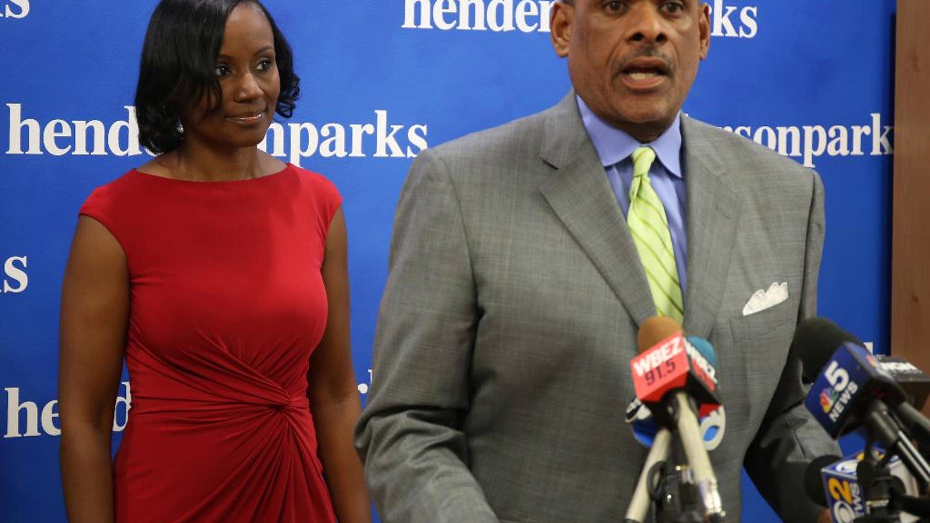 Rhonda Crawford,left, a court staff attorney fired after donning a robe and hearing real cases on the bench, listens to her lawyer Victor Henderson at a news conference in Chicago on Thursday, Sept.22, 2016. Crawford says she regrets overseeing several traffic cases. But she says the actual judge, Valarie E. Turner, stood over her the whole time and issued all rulings. Crawford was fired over the incident and Turner was removed from the bench indefinitely. (Phil Velasquez/Chicago Tribune via AP)