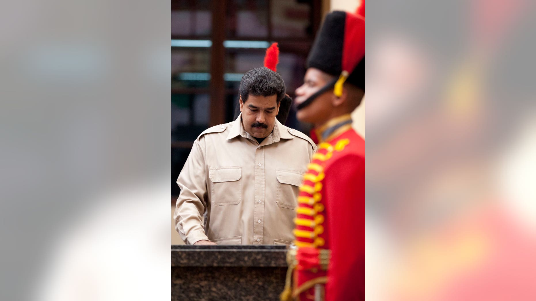 Venezuela’s President Nicolas Maduro visit the tomb of the late President Hugo Chavez, at the Military Museum in Caracas, Venezuela, Tuesday, Nov. 5, 2013. Maduro's decree establishing Dec. 8 as a public holiday in honor of Chavez was announced Tuesday. The holiday will commemorate Chavez's final public appearance, when the cancer stricken leader anointed Maduro as his successor. (AP Photo/Ariana Cubillos)