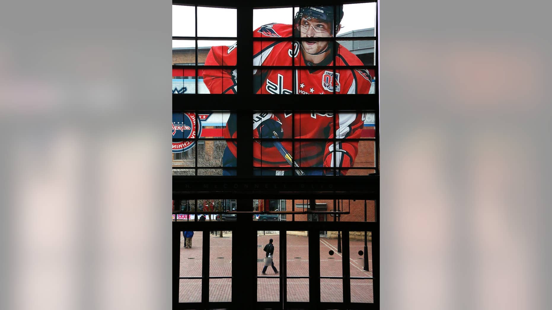 A large photo of Washington Capitals captain and All-Star Alex Ovechkin adorns the windows above and entrance to the Nationwide Arena for the NHL All-Star hockey weekend in Columbus, Ohio, Friday, Jan. 23, 2015. (AP Photo/Gene J. Puskar