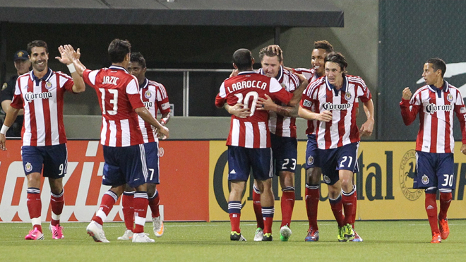 FILE - This July 28, 2012, file photo shows Chivas USA's Danny Califf (23) embraces teammate Nick LaBrocca (10) after he scores in the second half during an MLS soccer game with the Portland Timbers in Portland, Ore. Chivas USA ceased operations on Monday, Oct. 27, 2014, after 10 troubled and unsuccessful years in Major League Soccer, with the league planning a new franchise for Los Angeles that will begin play in 2017 with new ownership and a new soccer-specific stadium. (AP Photo/Rick Bowmer, File)