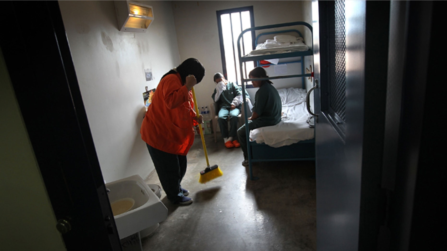 ELOY, AZ - JULY 30: A female detainee cleans a housing cell in a women's wing at an detention facility for illegal immigrants on July 30, 2010 in Eloy, Arizona. Most immigrants at the center are awaiting deportation or removal and return to their home countries, while some are interned at the facility while their immigration cases are being reviewed. The U.S. Immigration and Customs Enforcement (ICE), in Arizona holds almost 3,000 immigrants statewide, all at the detention facilities in Eloy and nearby Florence. Arizona, which deports and returns more illegal immigrants than any other state, is currently appealing a judge's ruling suspending controversial provisions of Arizona's immigration enforcement law SB 1070. (Photo by John Moore/Getty Images)