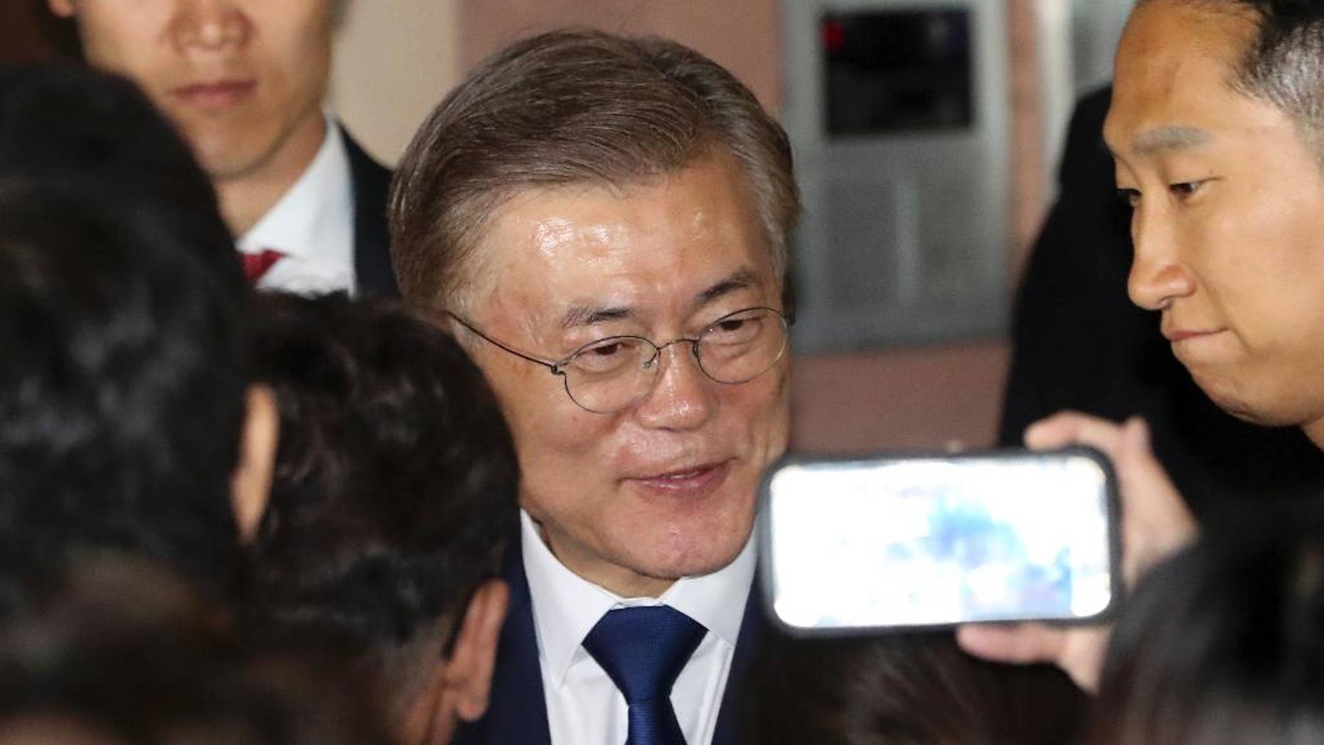 South Korea's presidential candidate Moon Jae-in of the Democratic Party is greeted by supporters in front of his house in Seoul, South Korea, Tuesday, May 9, 2017. Moon Jae-in declared victory in South Korea's presidential election Tuesday after his two main rivals conceded. (AP Photo/Lee Jin-man)